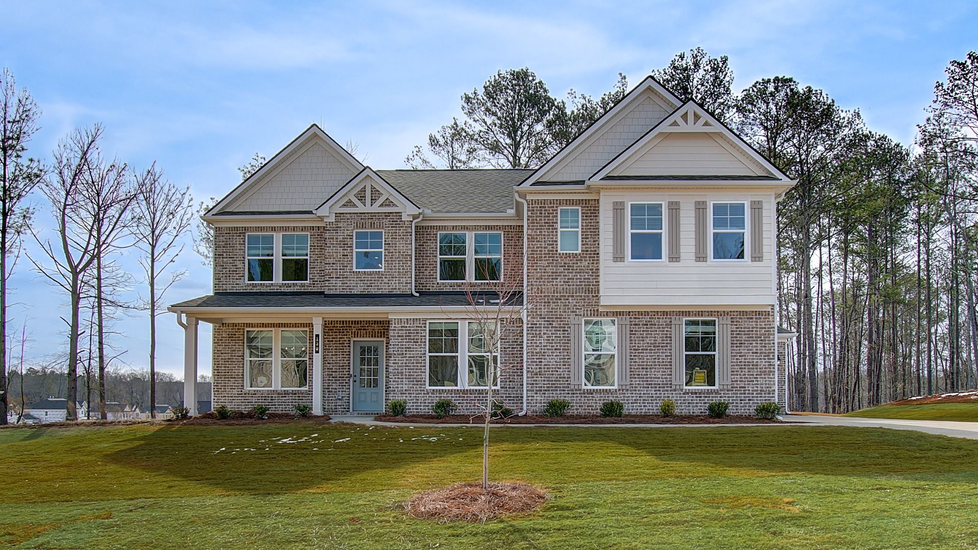 Rosemary two-story home with brick and siding exterior and side-entry garage at Trinity Park in McDonough, GA.