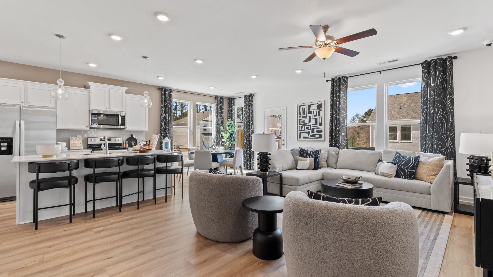 Inviting open-concept first floor with LVP flooring and natural light in the Austin Alternate at Bowers Farm Townhomes.