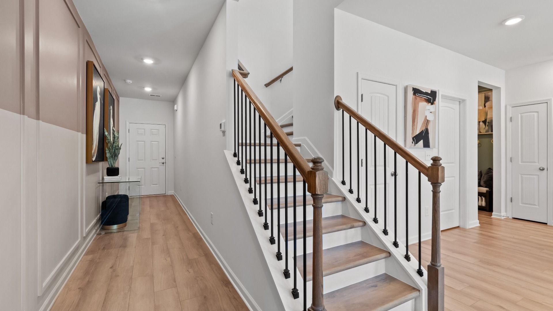 Austin Alternate open foyer and staircase with open railing and LVP flooring at Bowers Farm Townhomes in McDonough, GA.