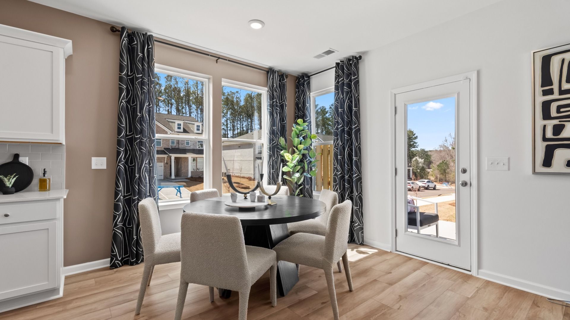 Bright Austin Alternate breakfast area with comfortable seating and view to outdoor porch at Bowers Farm Townhomes.