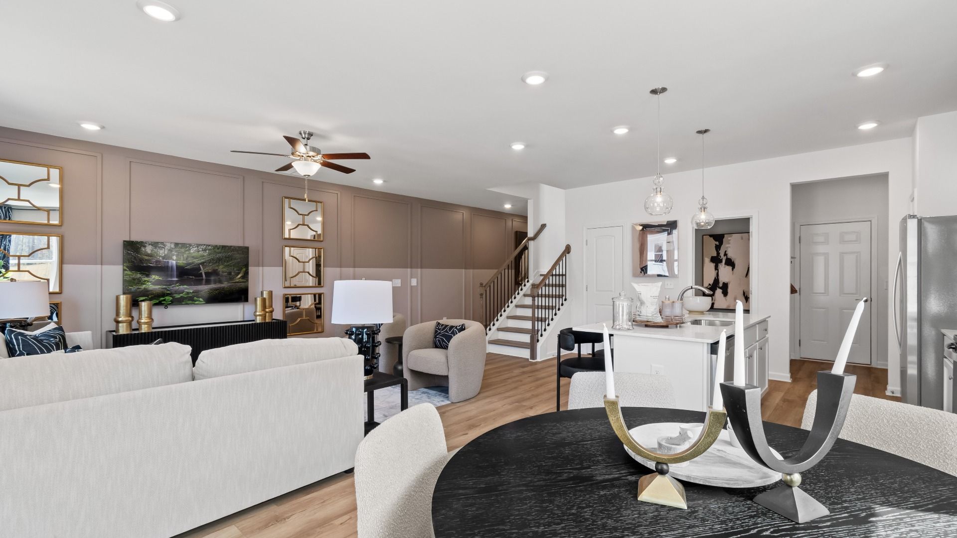 Open-concept first floor with LVP flooring and modern connected layout in the Austin Alternate at Bowers Farm Townhomes.