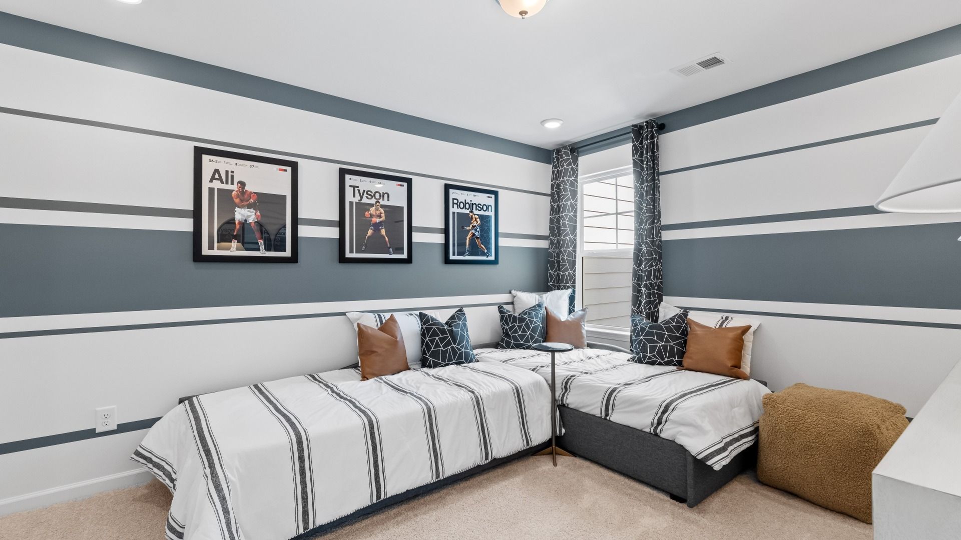 Carpeted secondary bedroom with natural light in the Austin Alternate at Bowers Farm Townhomes in McDonough, GA.