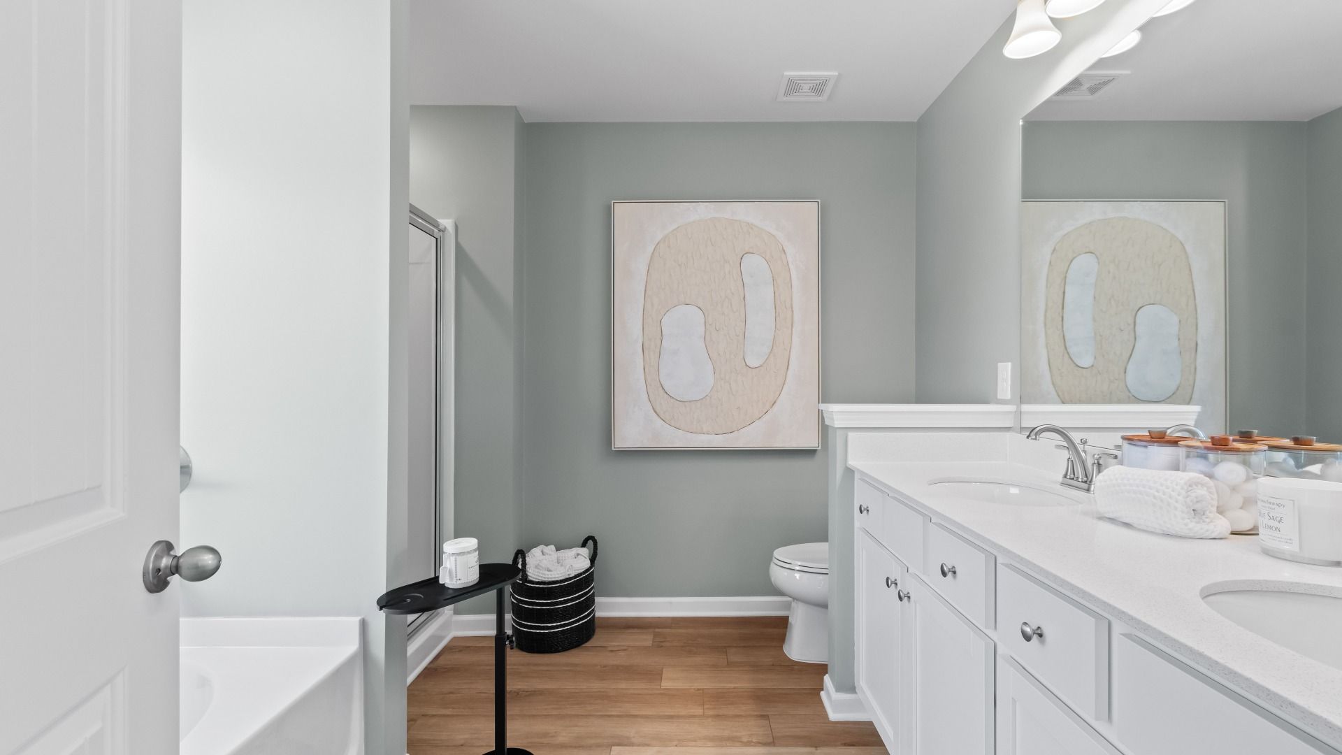 Modern primary bath with standalone tub, walk-in shower, and dual vanities in the Austin Alternate at Bowers Farm Townhomes.