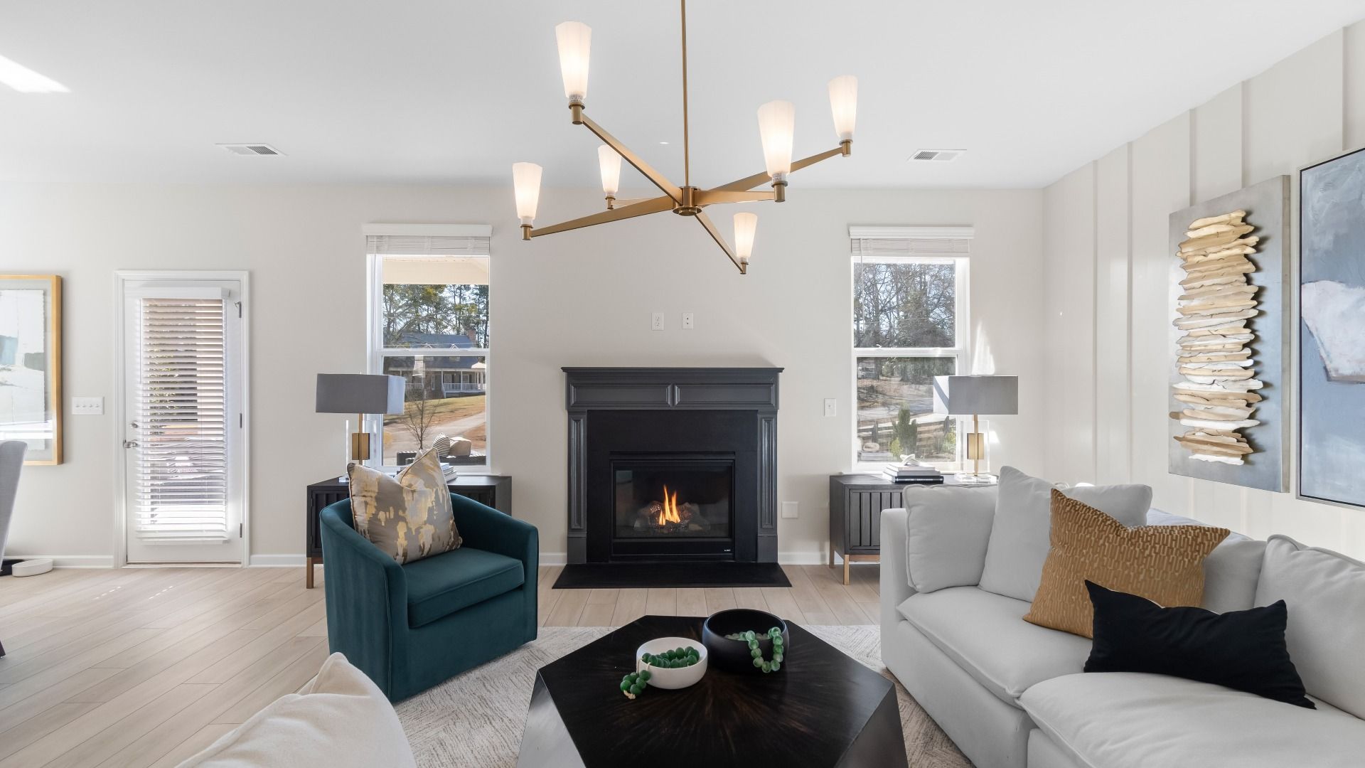 Ridgewood open family room with gas fireplace, natural light, and modern finishes at Burchwood in Stockbridge, GA.