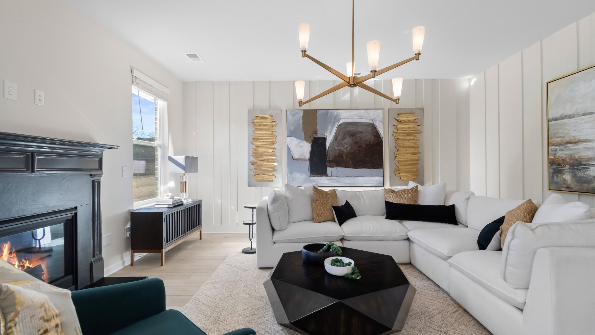 Ridgewood open family room with gas fireplace, natural light, and modern finishes at Burchwood in Stockbridge, GA.