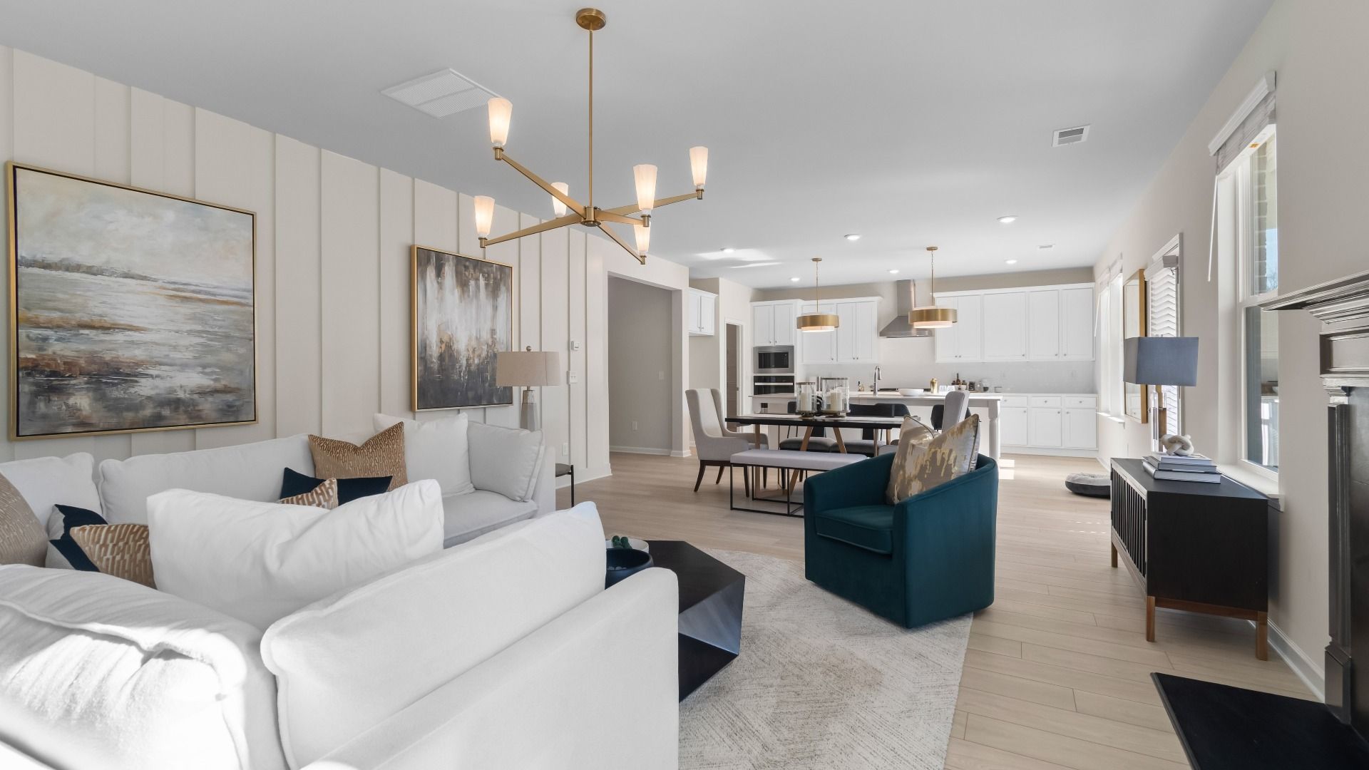 Open-concept family room with LVP flooring, ample seating area, and neutral modern finishes at Burchwood in Stockbridge, GA.