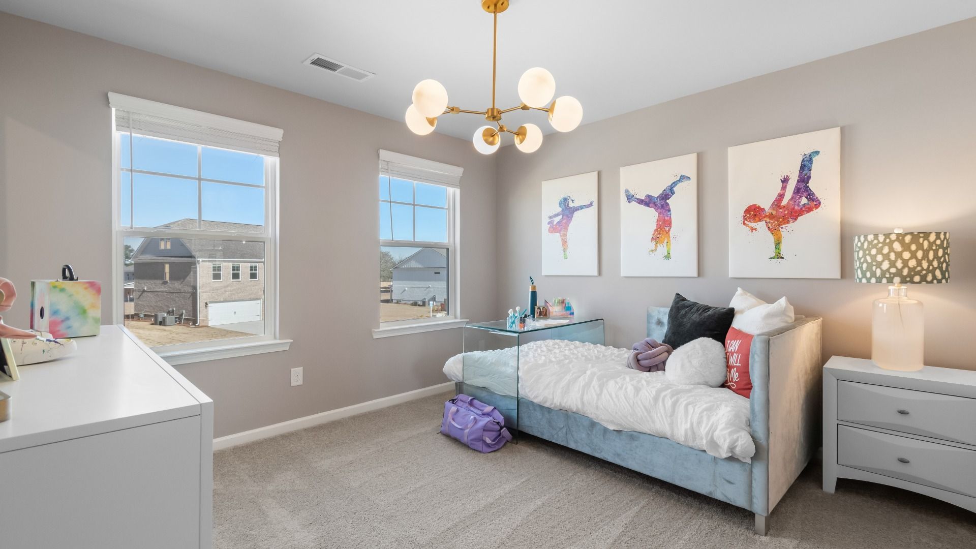 Secondary bedroom with carpet flooring and windows providing natural light in the Ridgewood at Burchwood in Stockbridge, GA.