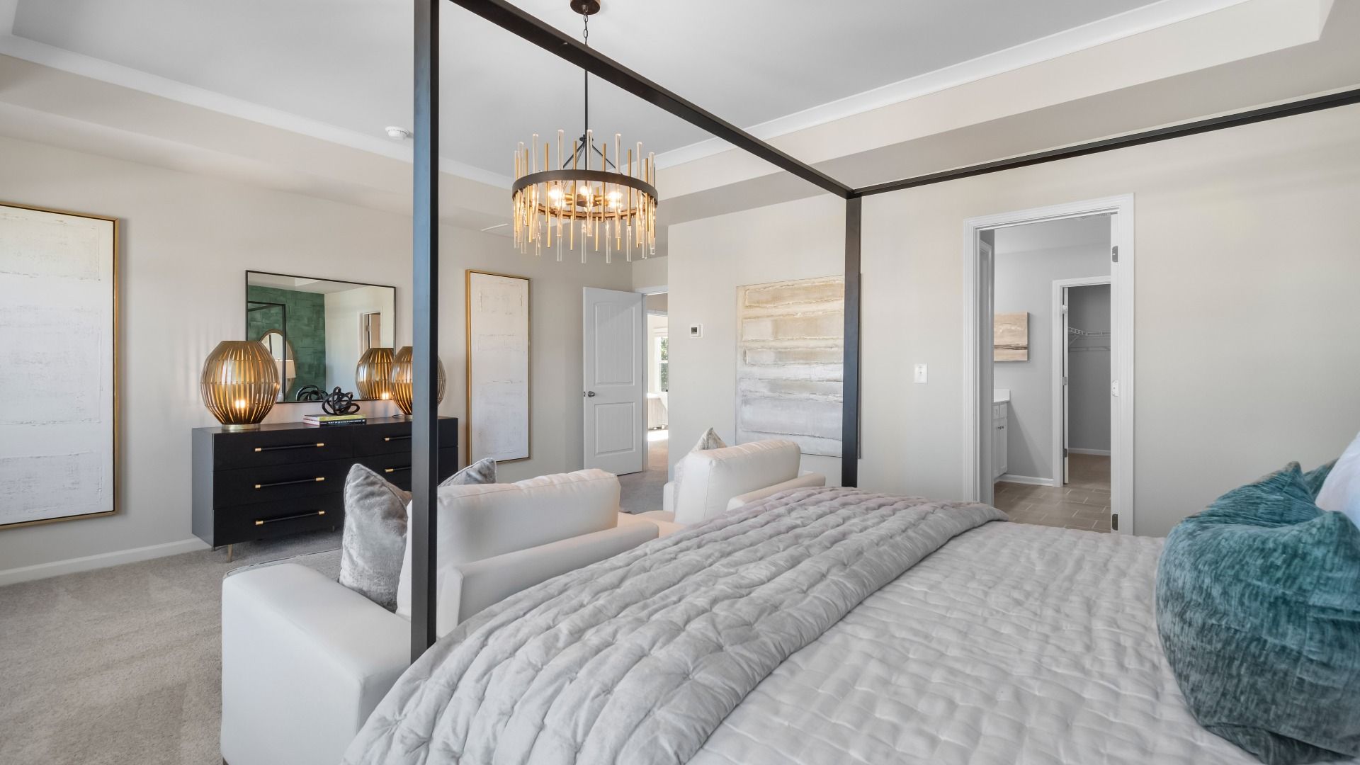 Ridgewood spacious primary suite with seating area, carpet flooring, and connected primary bath at Burchwood.