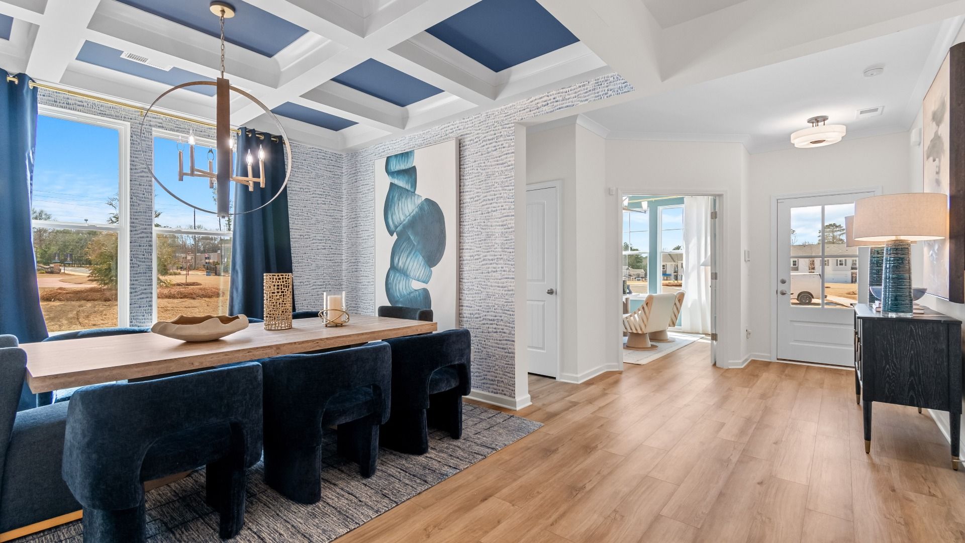 Open dining room with coffered ceiling, natural light, and LVP flooring in the Wynwood at Bowers Farm in McDonough, GA.