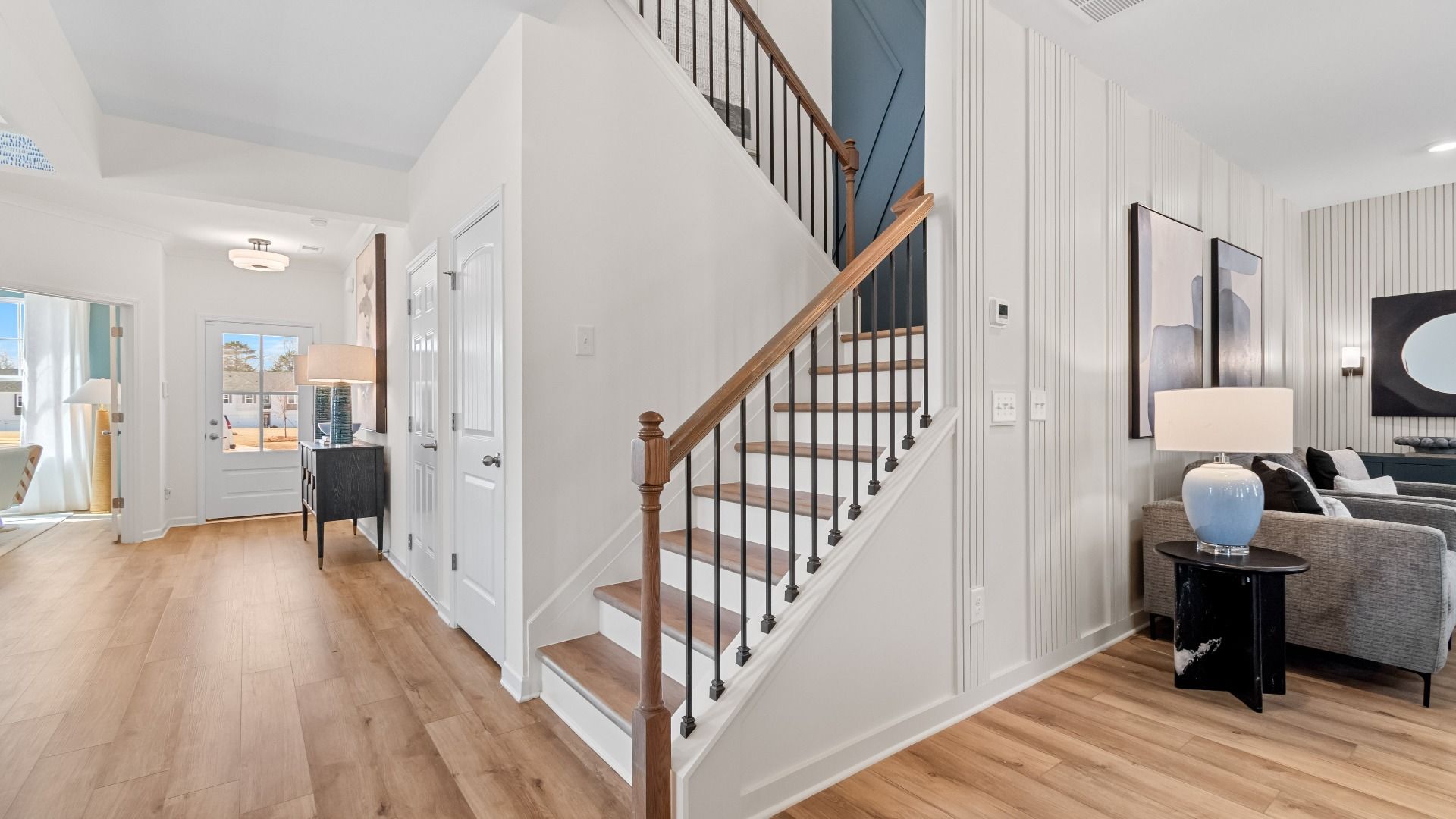 Wynwood staircase off family room with open railing and LVP flooring at Bowers Farm in McDonough, GA.