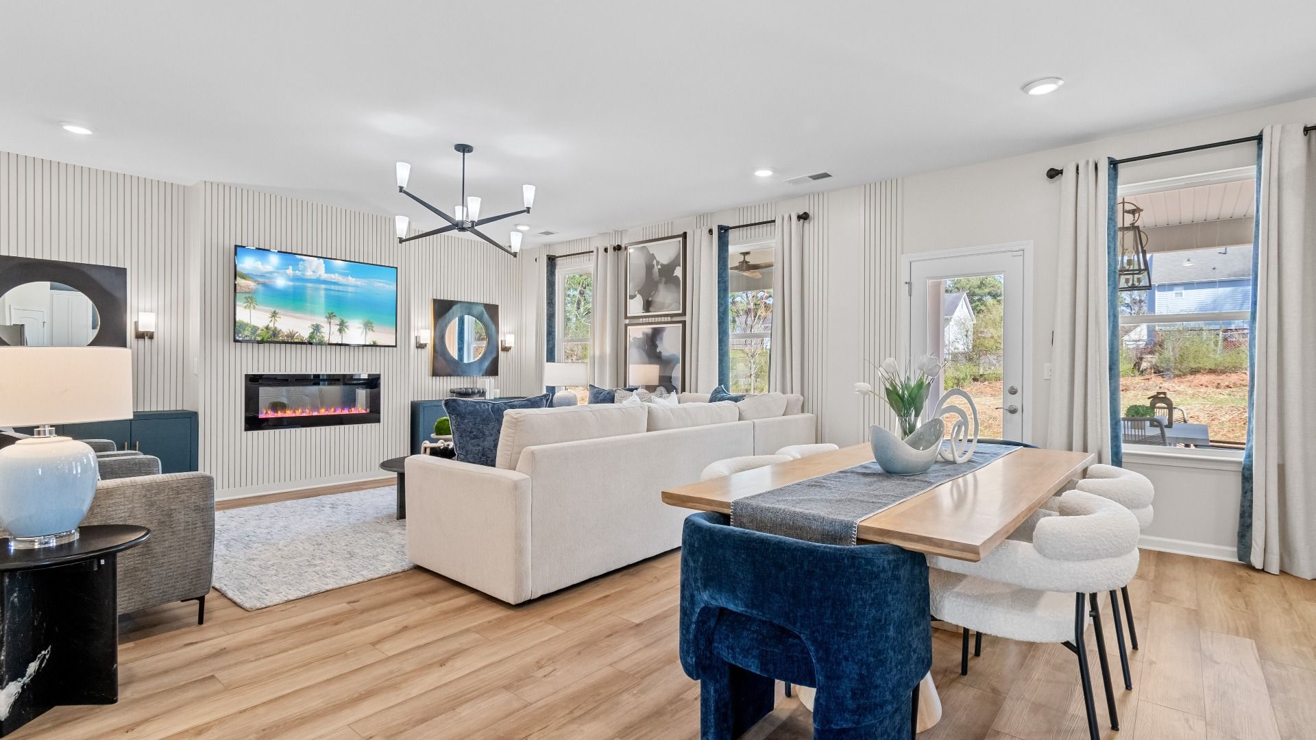Open first floor with seamless connection of breakfast area and family room with LVP flooring in the Wagener at Bowers Farm.