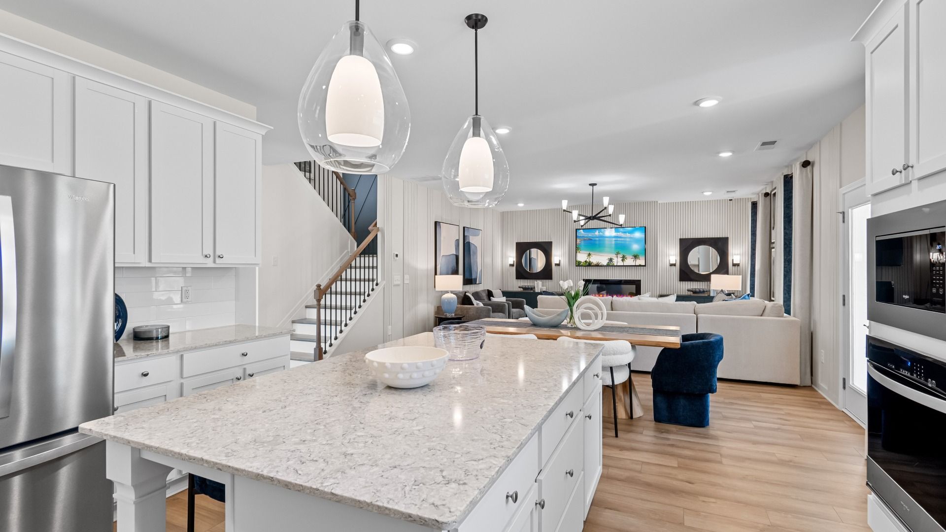 Open-concept kitchen with center island, pendant lighting, and natural light in the Wynwood at Bowers Farm in McDonough, GA.