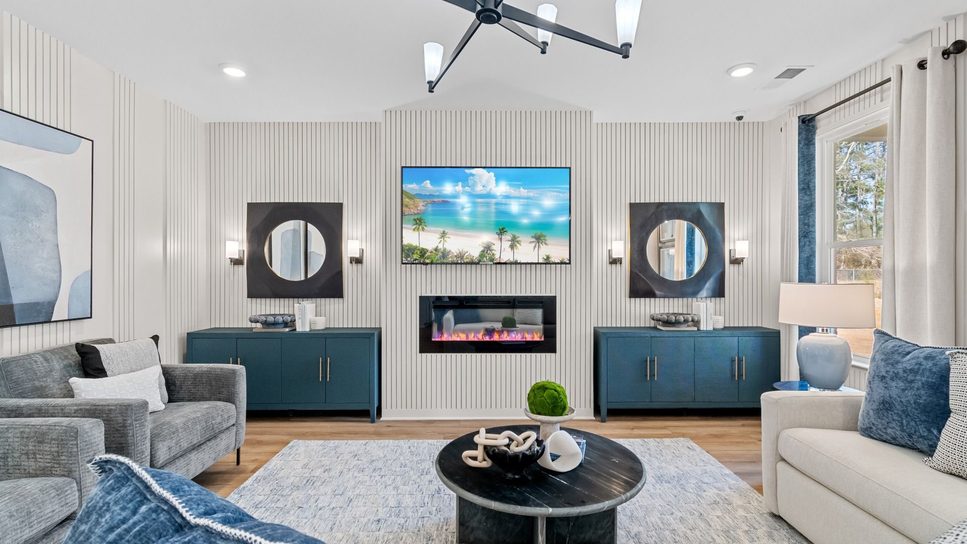 Bright and open Wynwood family room with LVP flooring, luxury electric fireplace, and neutral modern features at Bowers Farm.