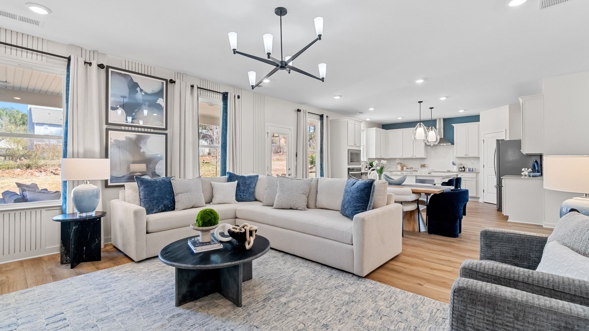 Expansive Wynwood family room with ample seating area, LVP flooring, and modern finishes at Bowers Farm in McDonough, GA.