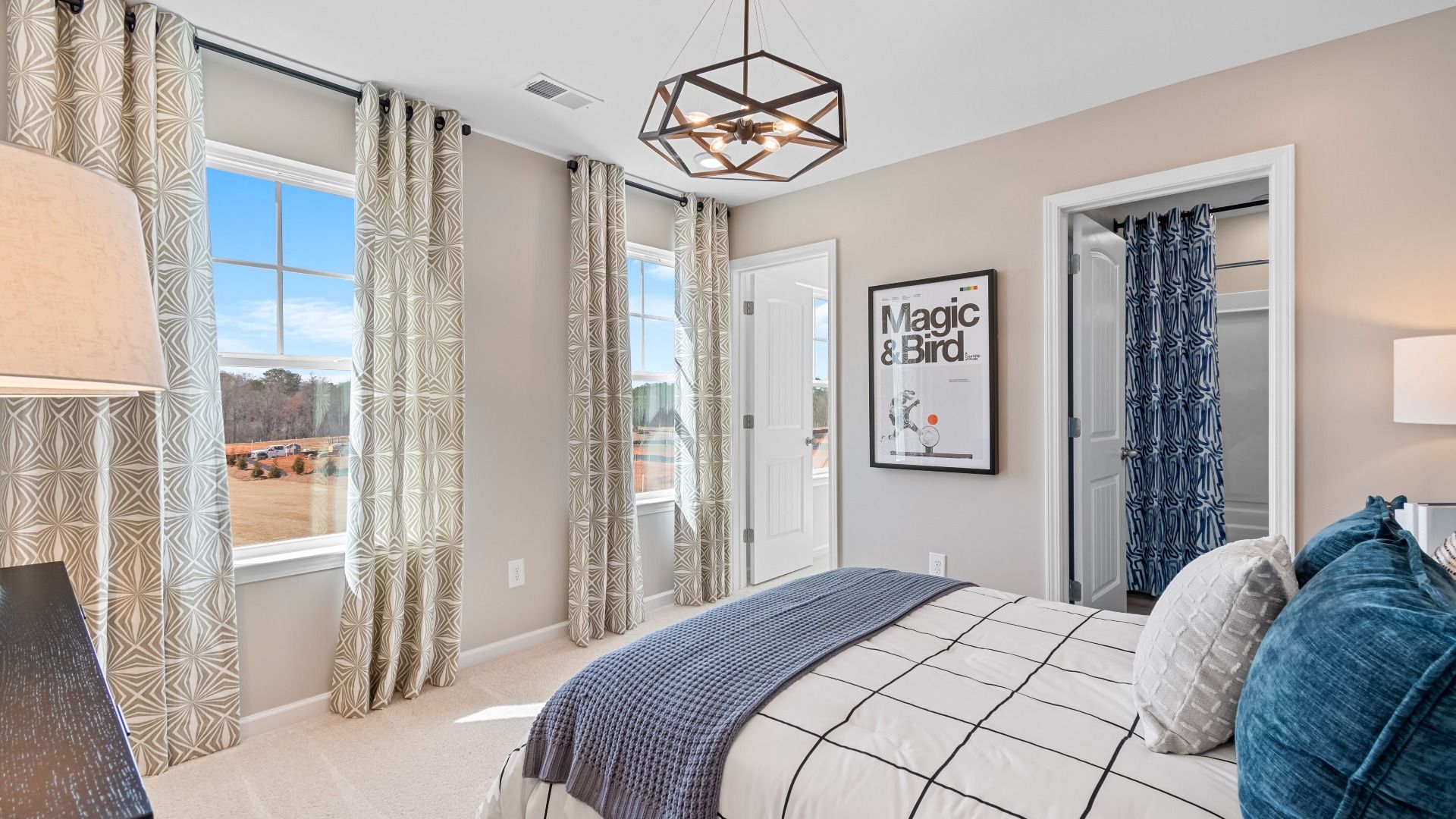 Cozy Wynwood secondary bedroom with connecting bath, carpet flooring, and natural light at Bowers Farm in McDonough, GA.