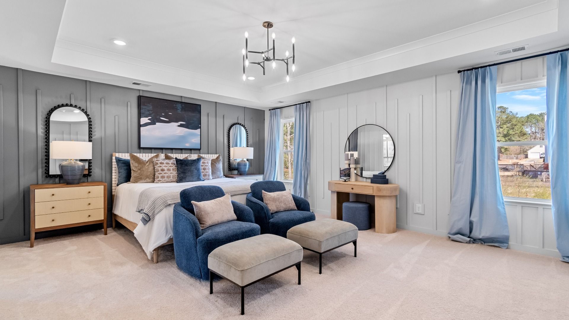 Retreat-style primary suite with tray ceiling, carper flooring, and natural light in the Wynwood at Bowers Farm.
