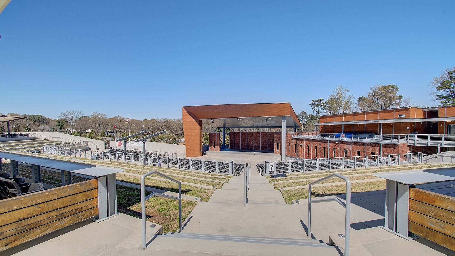 Nearby amphitheater with tiered seating, open lawn, and a covered stage near Burchwood new construction home community.