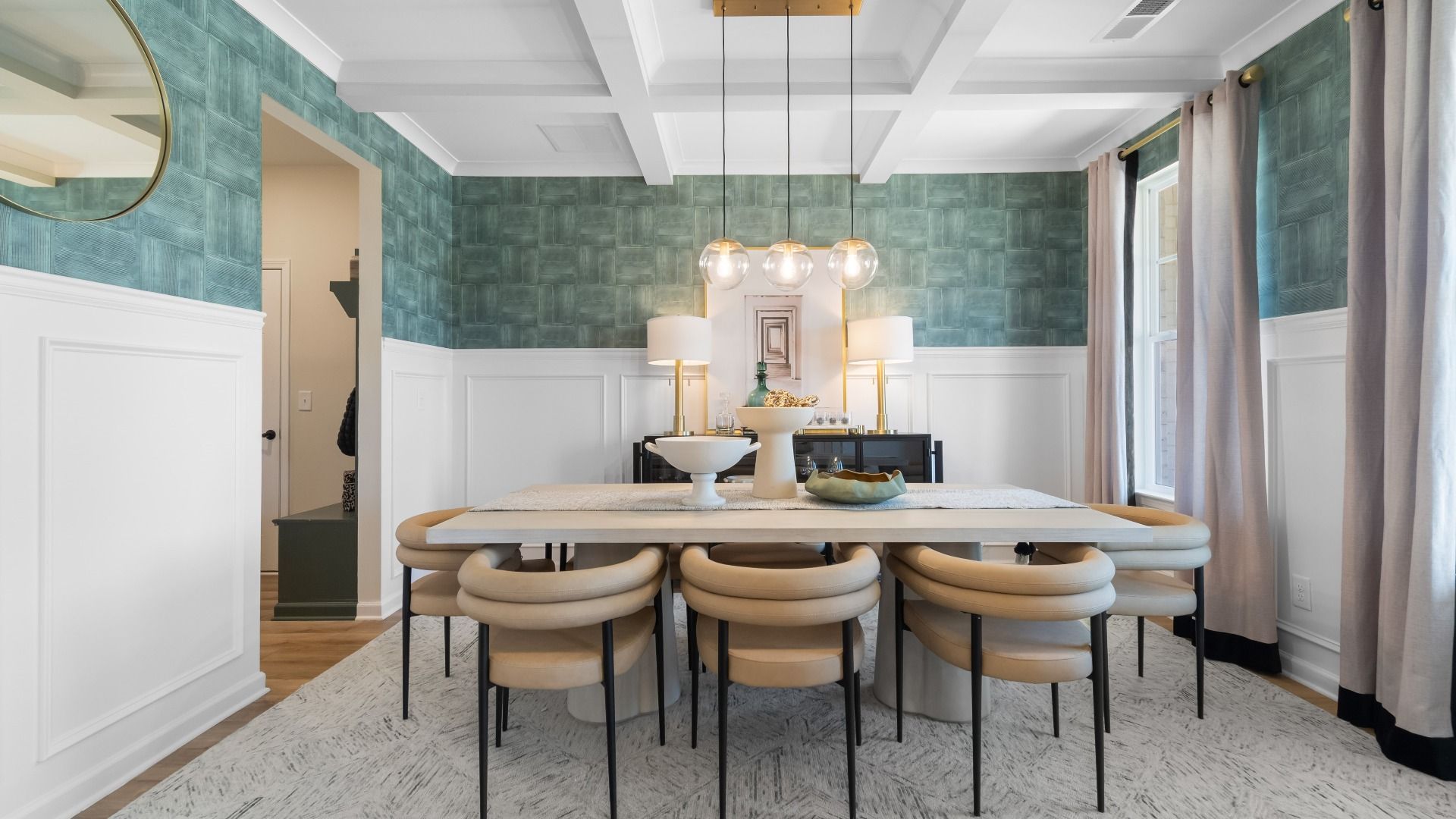 Elegant dining room with coffered ceiling and natural light at Cambria at Traditions in Hampton, GA.