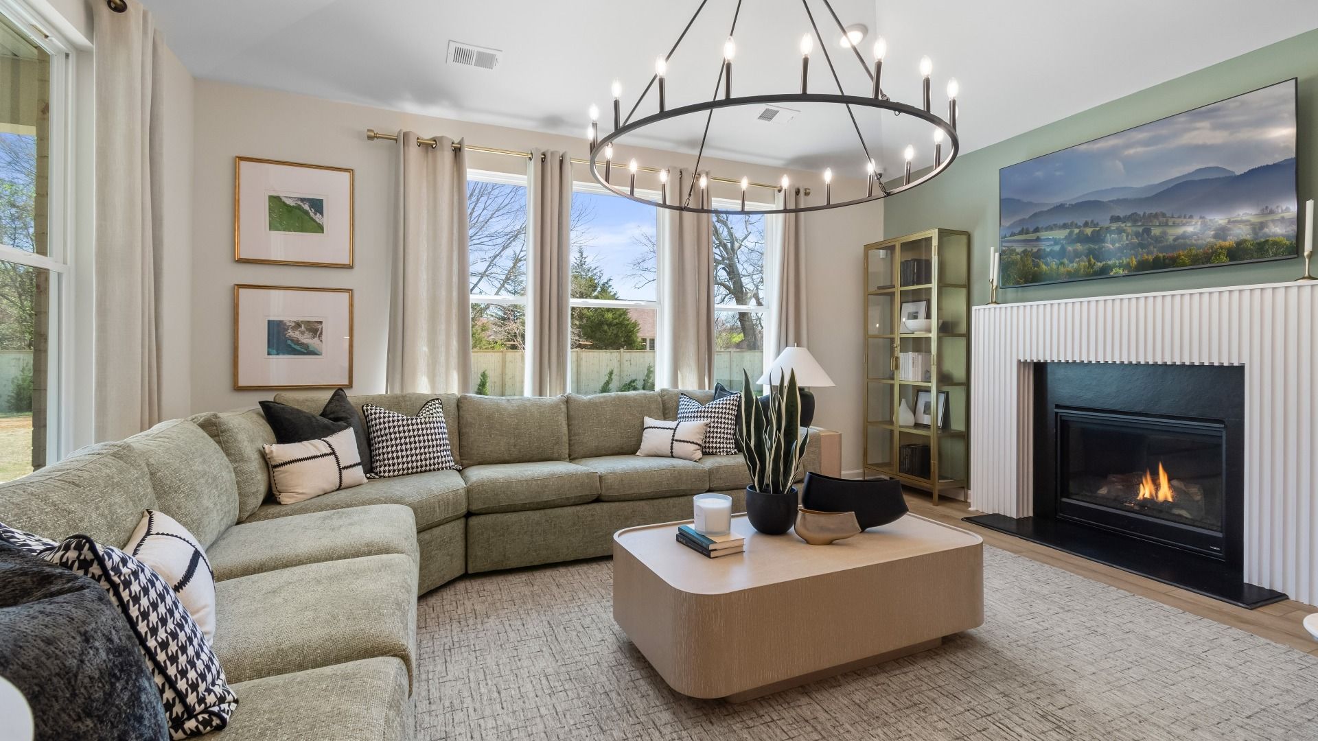 Spacious family room with gas fireplace and abundant natural light at Cambria at Traditions in Hampton, GA.