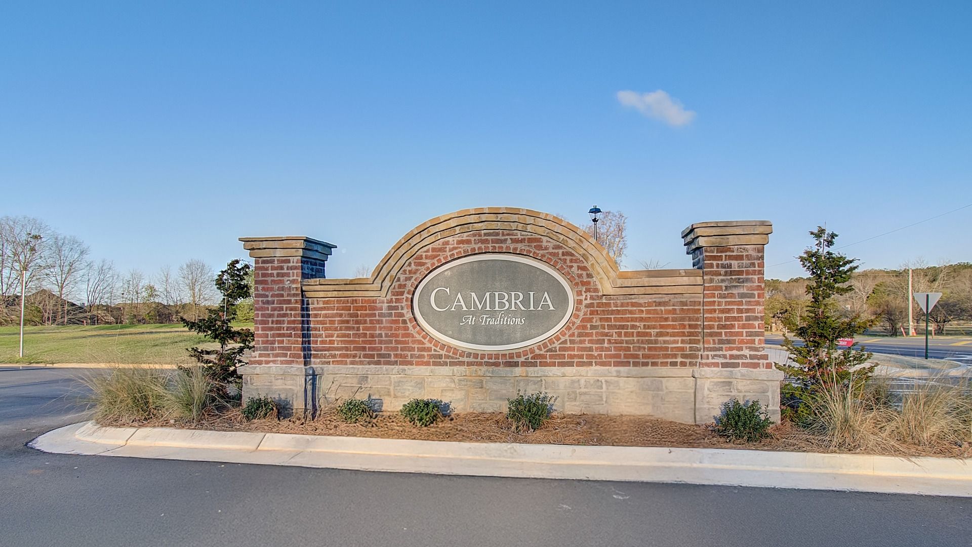Brick and stone entry monument welcoming residents and guests at Cambria at Traditions community in Hampton, GA.