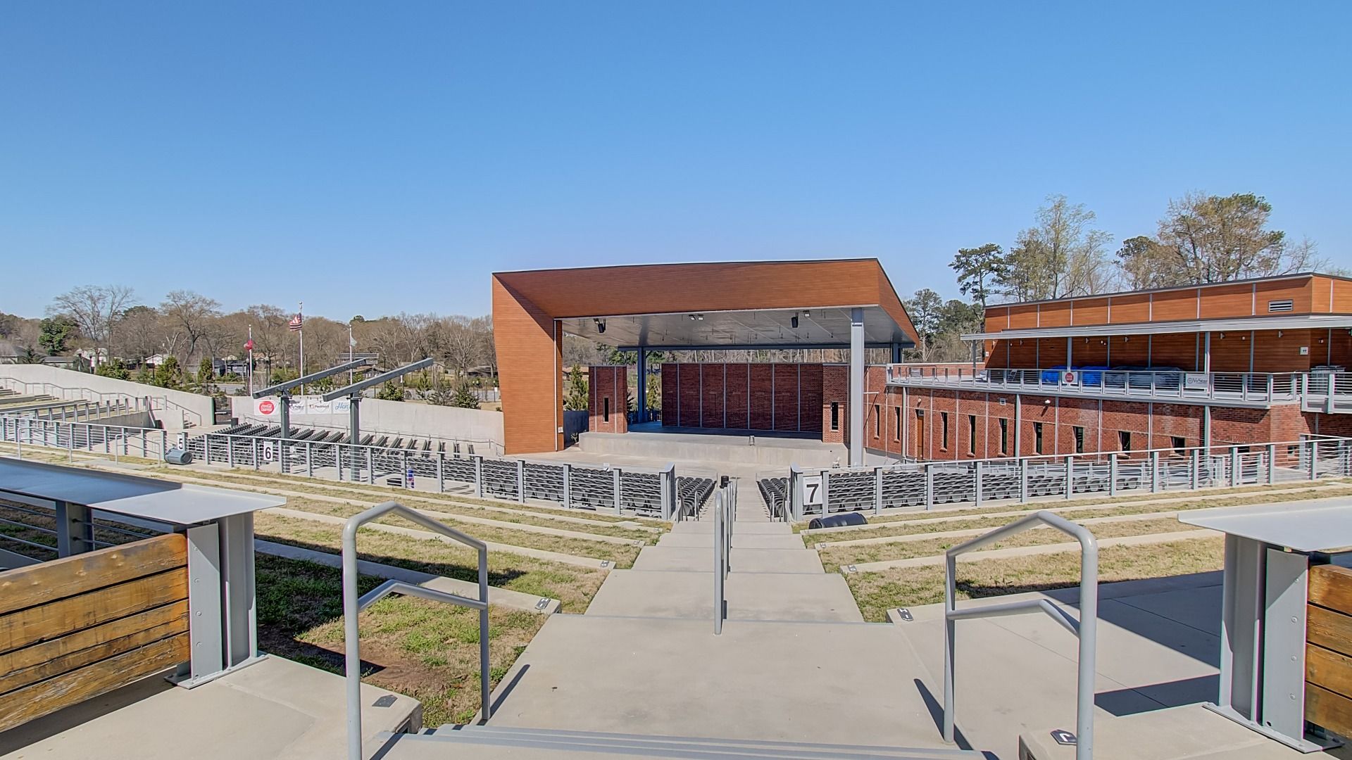 Nearby amphitheater with tiered seating, open lawn, and a covered stage near Diamante new construction townhome community.