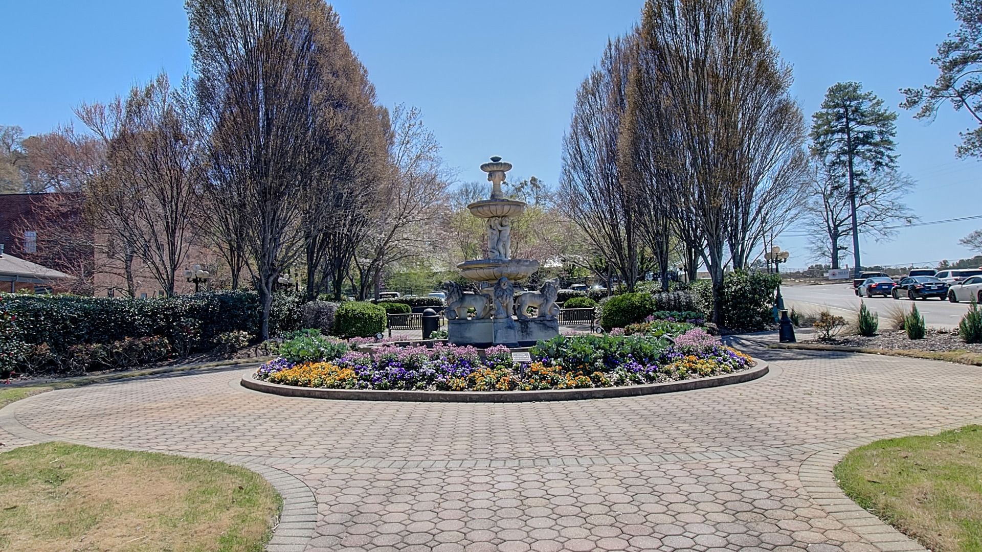 Charming Municipal Park with mature trees, a fountain, and landscaped flowers near the Diamante community in Stockbridge, GA.