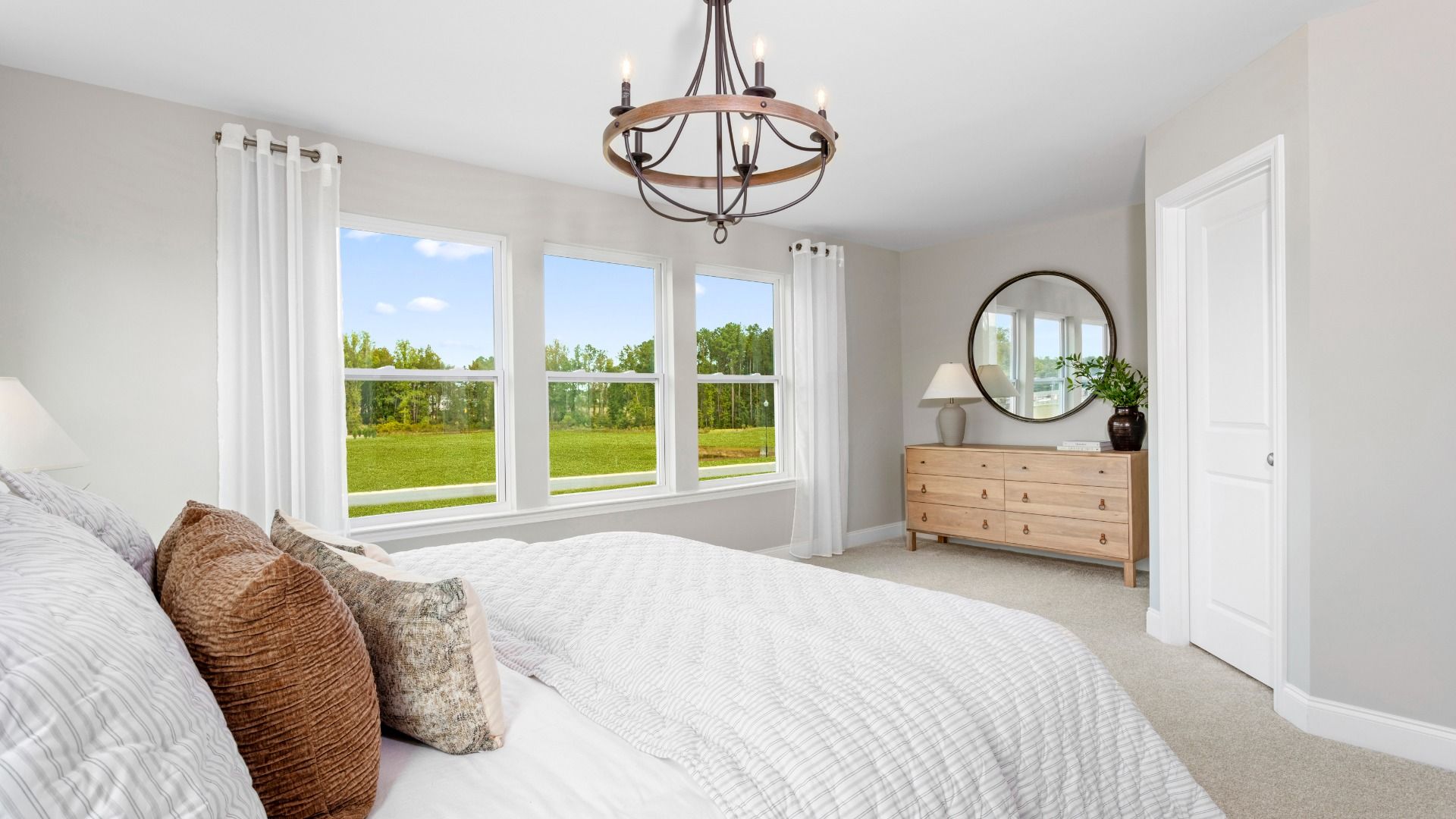 Spacious primary bedroom with large windows in The Litchfield townhome design at Bell Glen by DRB Homes Charlotte, NC