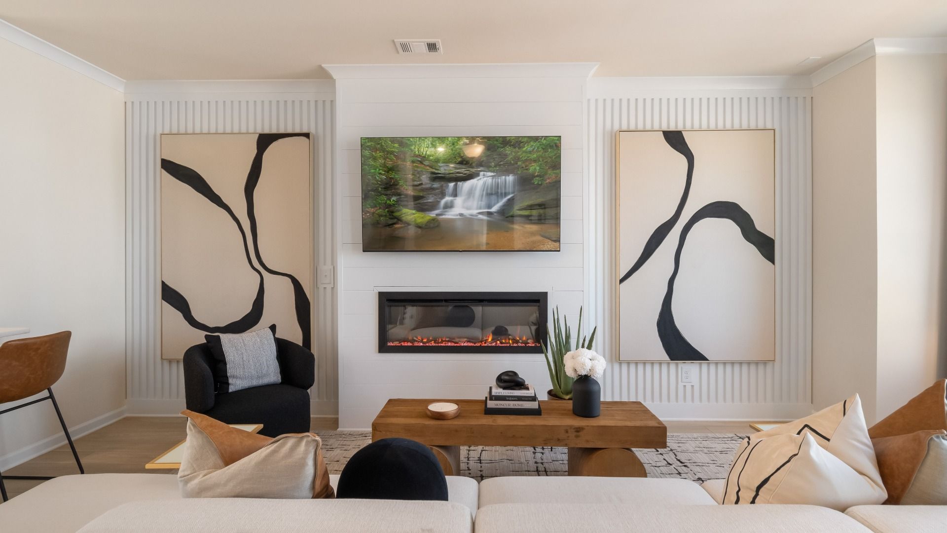 Spacious family room featuring electric fireplace and neutral modern design in new construction townhome at Silverock.