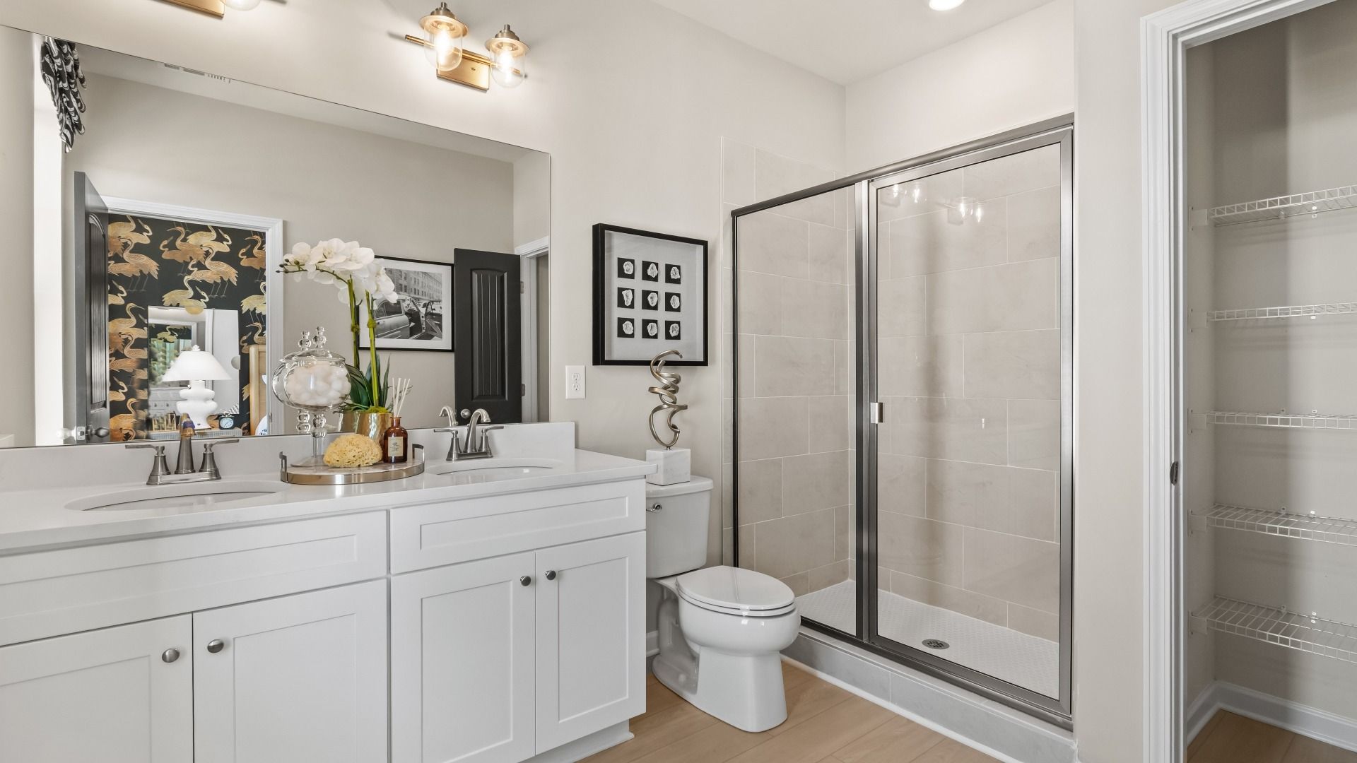 Primary bath featuring dual vanity and tiled walk-in shower at Silverock in McDonough, GA.