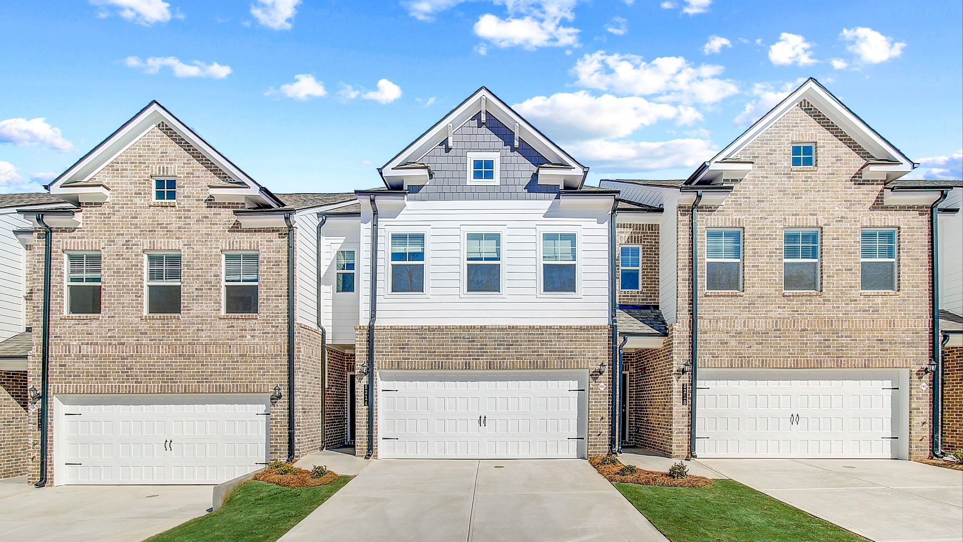 New construction townhome with James Hardie plank siding and brick detailing in townhome community in Riverdale, GA.