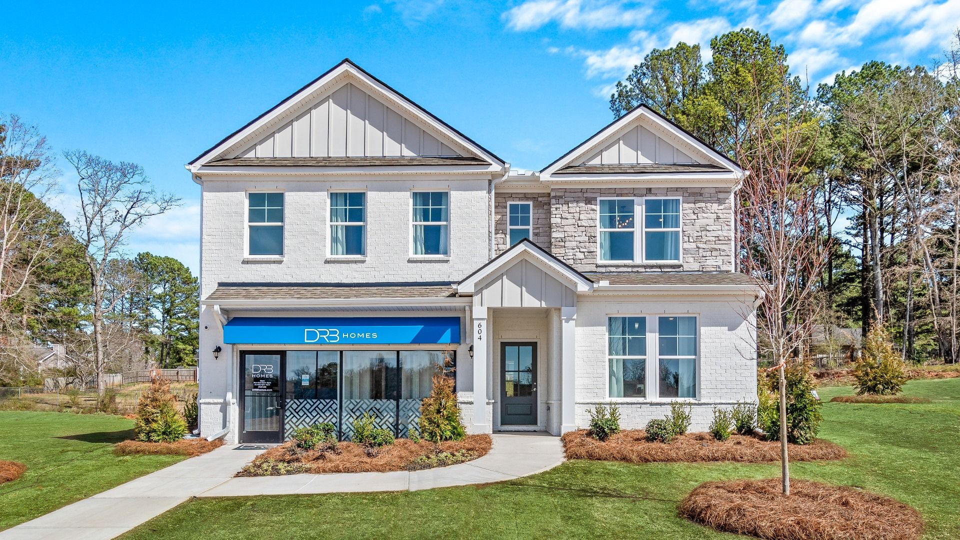 Wynwood model home showing brick and stone exterior at Bowers Farm in McDonough, GA.