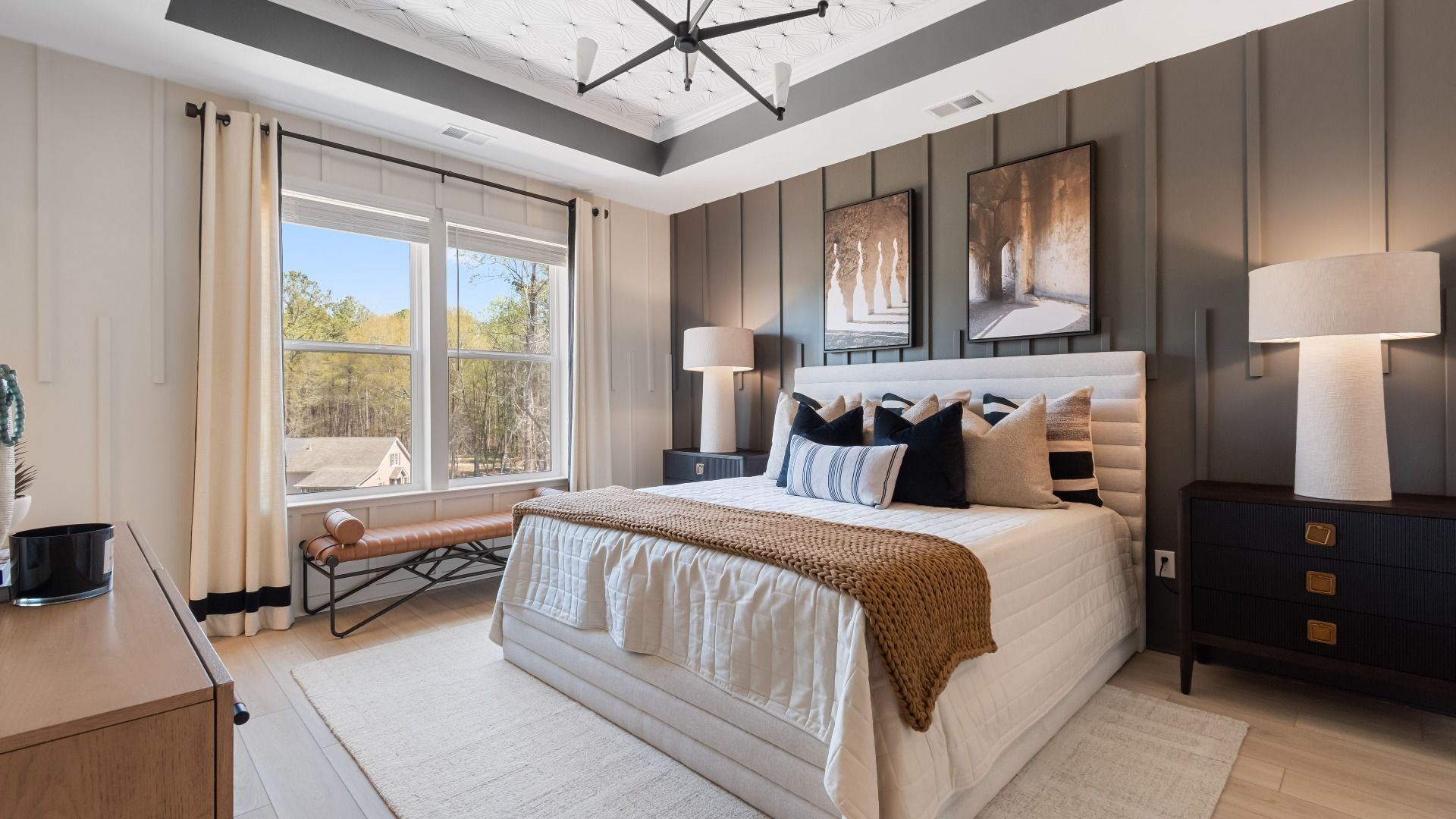 Spacious primary suite featuring tray ceiling, abundant natural light, and modern wall finishes at Daybreak in Newnan, GA.