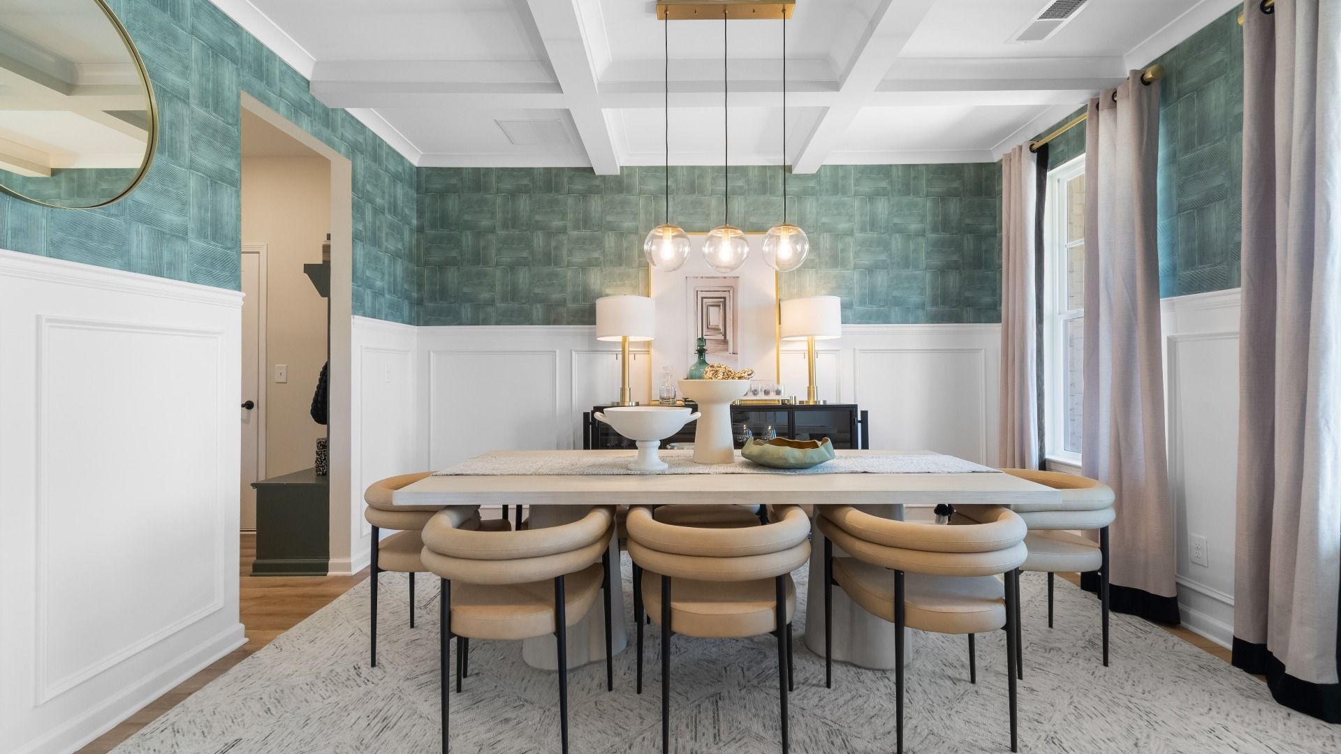 Spacious dining room with coffered ceiling, modern design, and large windows at The Park at Brighton in Locust Grove, GA.