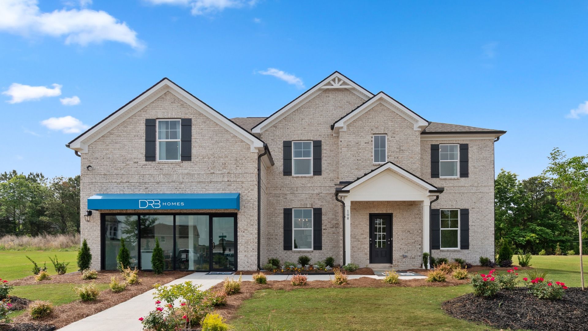 Meridian model home with four-sided light brick exterior and landscaped front yard at Westwind Estates in Hampton, GA.