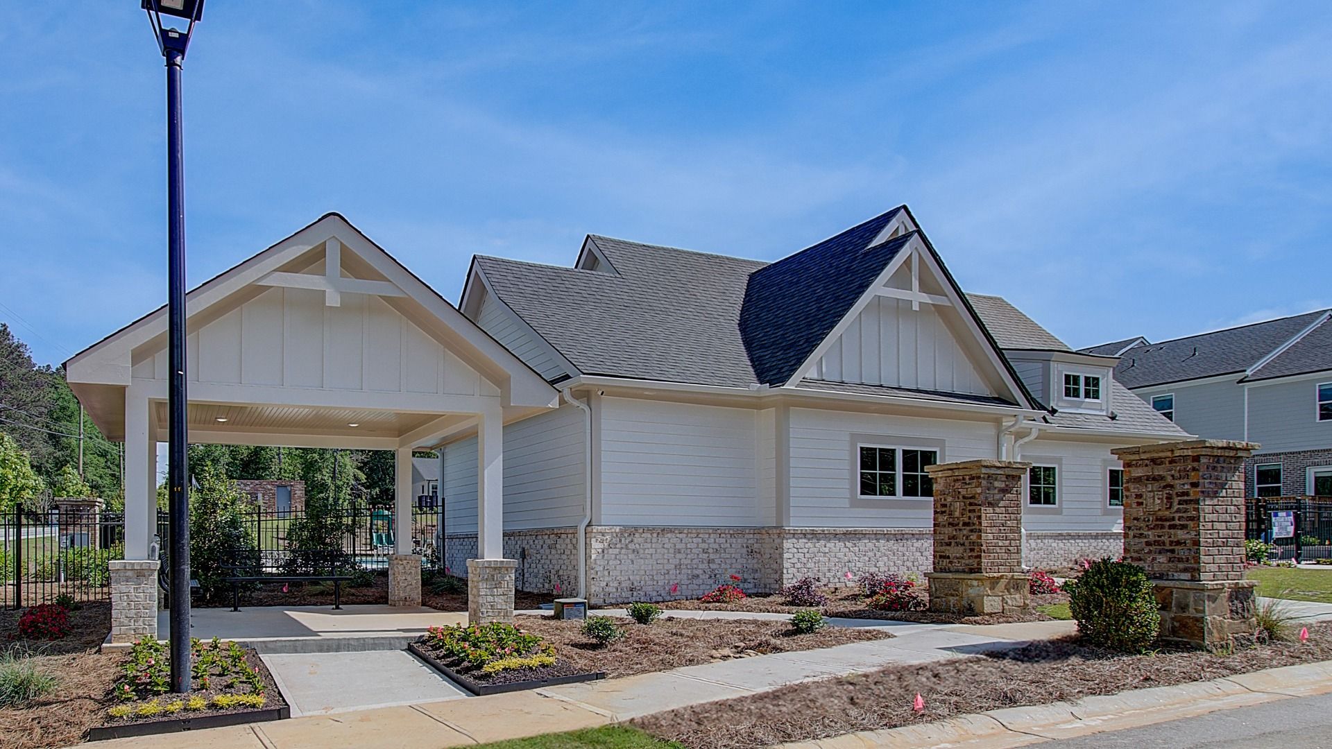 Community clubhouse entrance at Diamante with covered gathering space and landscaped walkways in Stockbridge, GA.
