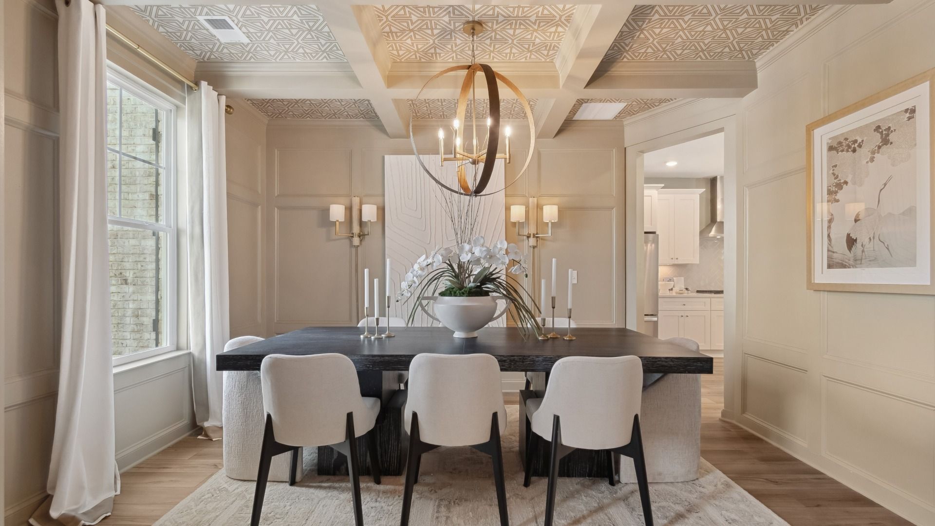Elevated dining room with coffered ceiling, large window, and neutral tones at Westwind Estates in Hampton, GA.