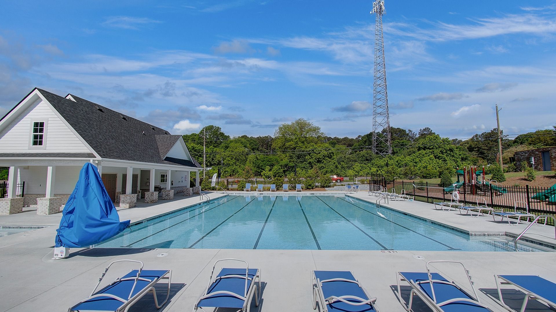 Community swimming pool with lounge seating at new construction townhome community in Diamante in Stockbridge, GA.