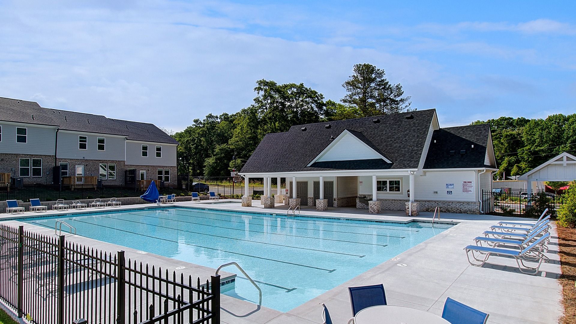 Fenced community pool at Diamante with lounge chairs and shaded pavilion area in Stockbridge, GA.