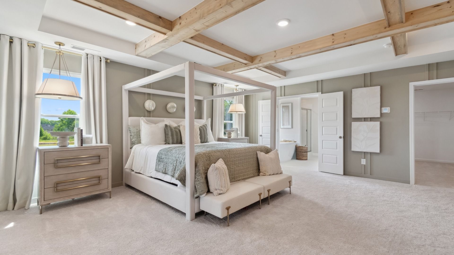 Expansive primary suite featuring beamed ceiling, carpet flooring, and spacious layout at Westwind Estates in Hampton, GA.