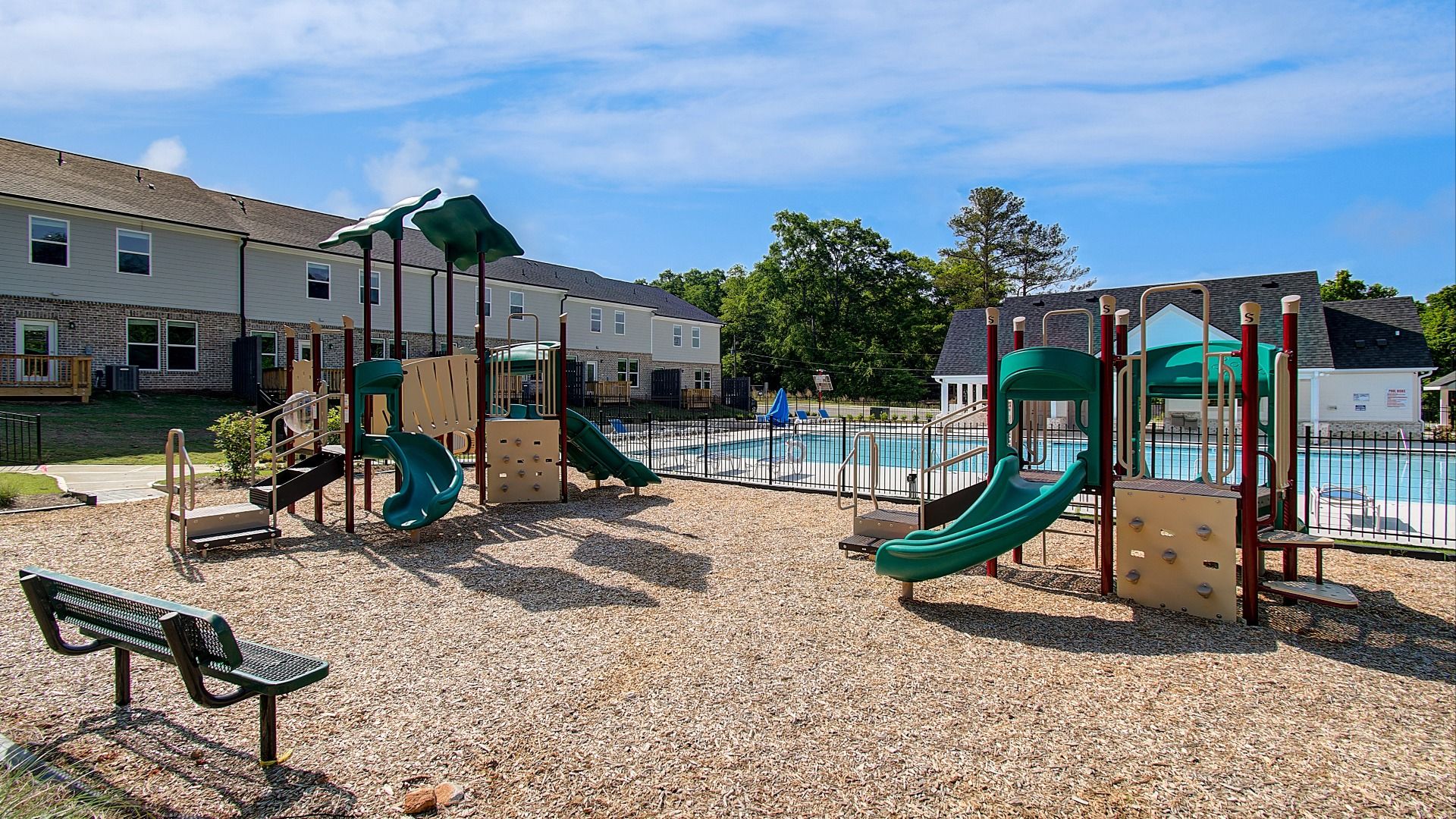 Diamante outdoor amenities showing playground equipment next to the community pool in Stockbridge, GA.