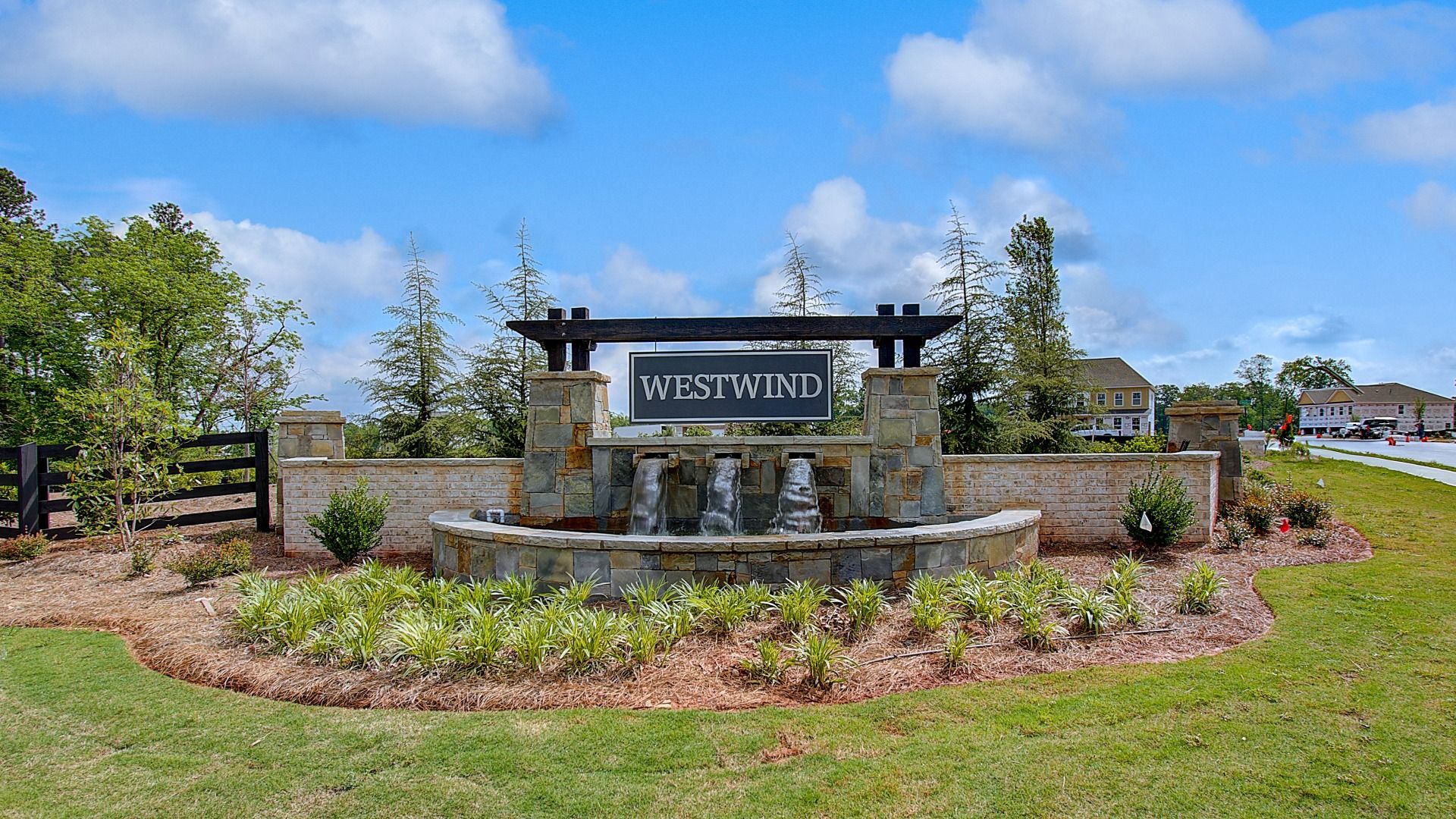 Stone entrance monument with landscaped surroundings at Westwind Estates in Hampton, GA.