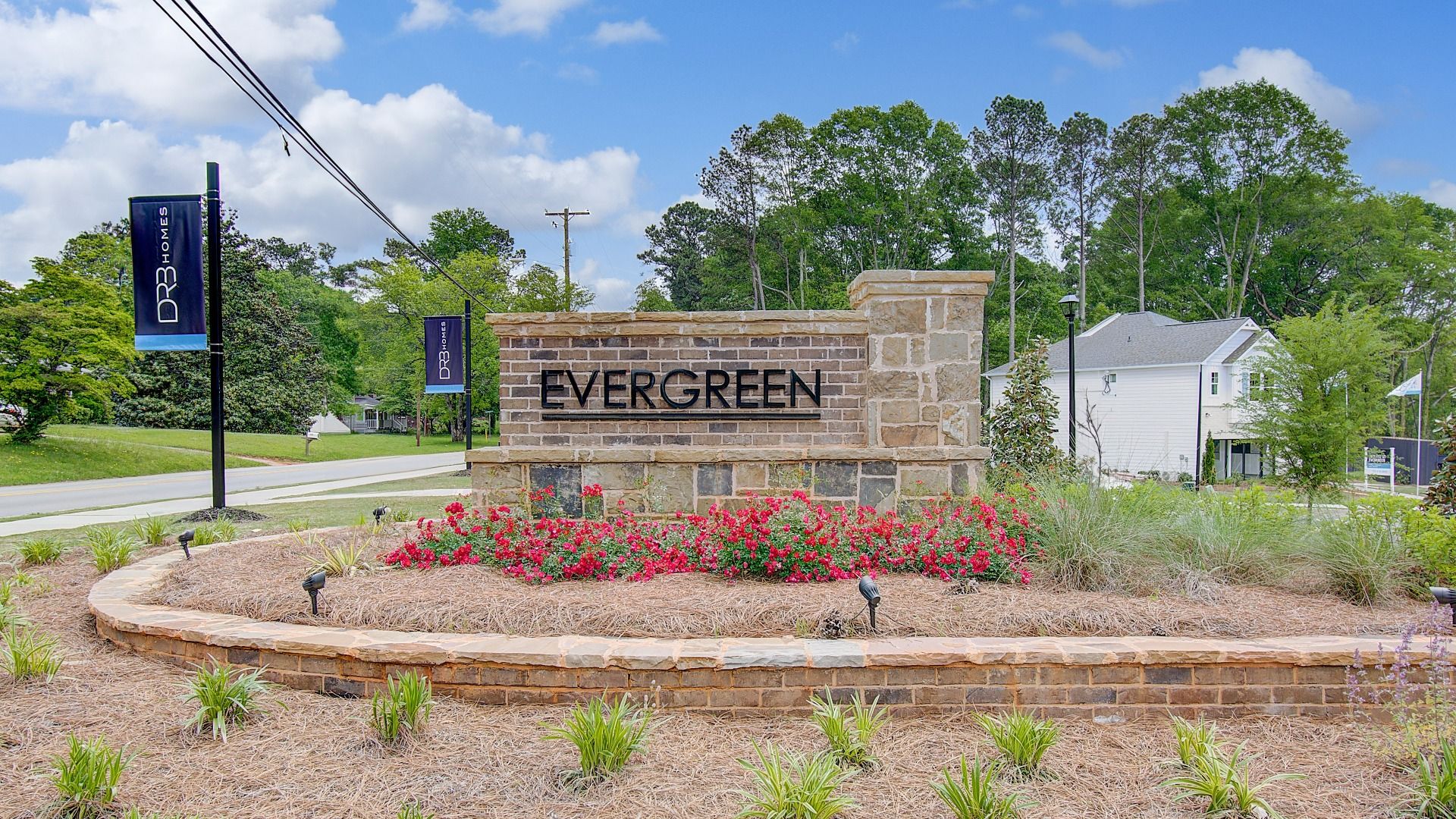 Entry monument with brick and stone detailing at Enclave at Evergreen in Fairburn, GA.