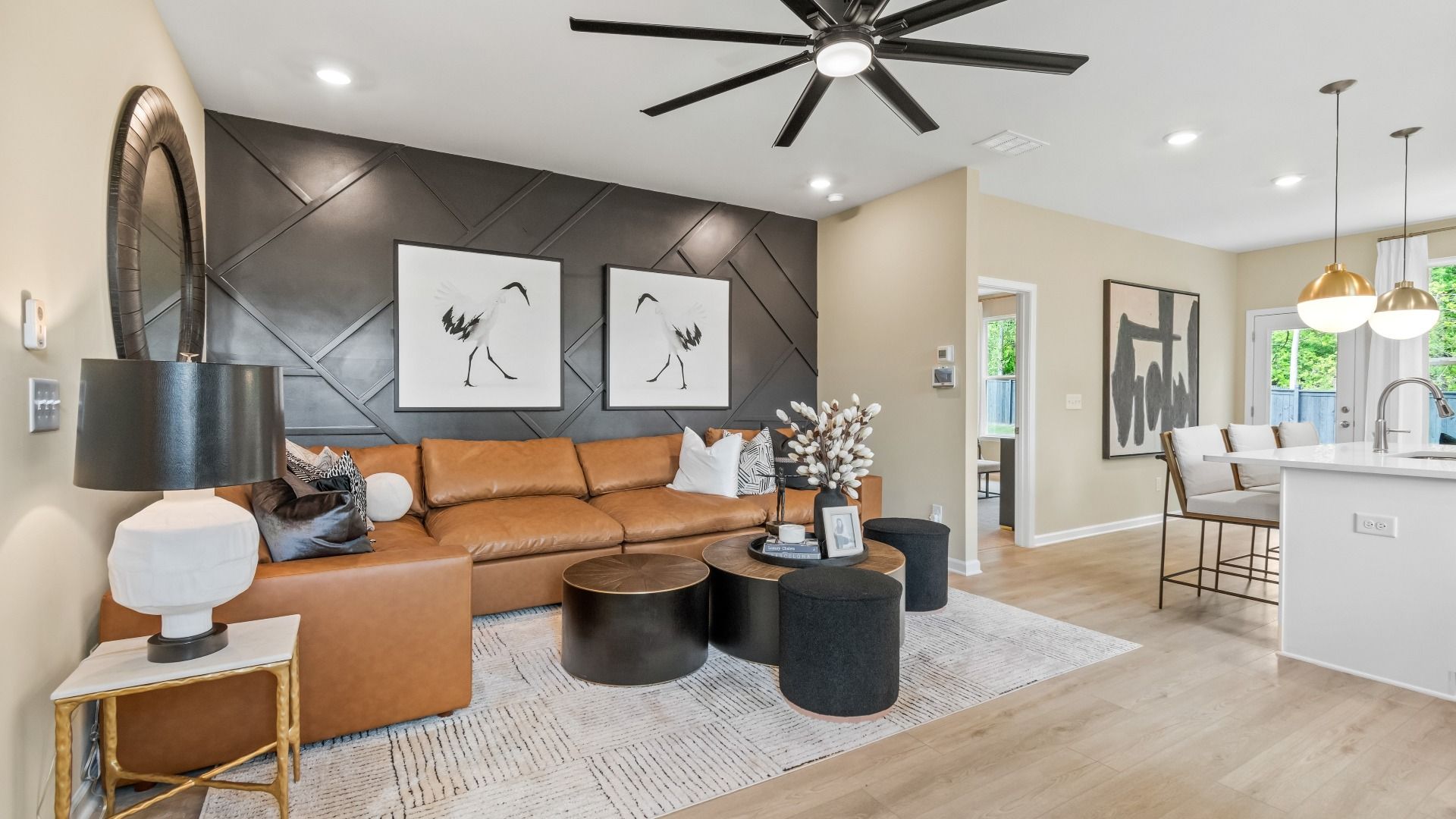 Open living space featuring ceiling fan and contemporary designs at Enclave at Evergreen in Fairburn, Georgia.
