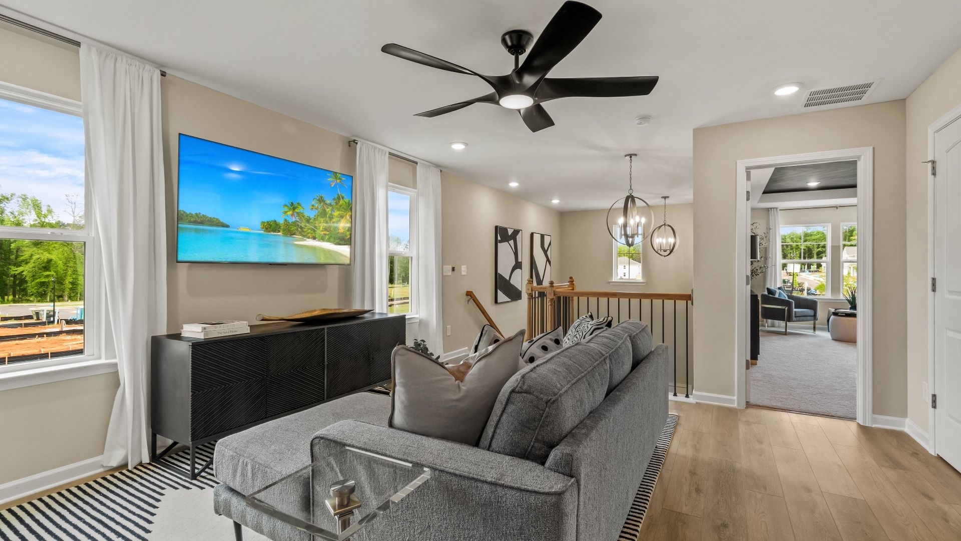 Versatile open loft space with large windows in a new construction single-family home at Enclave at Evergreen.