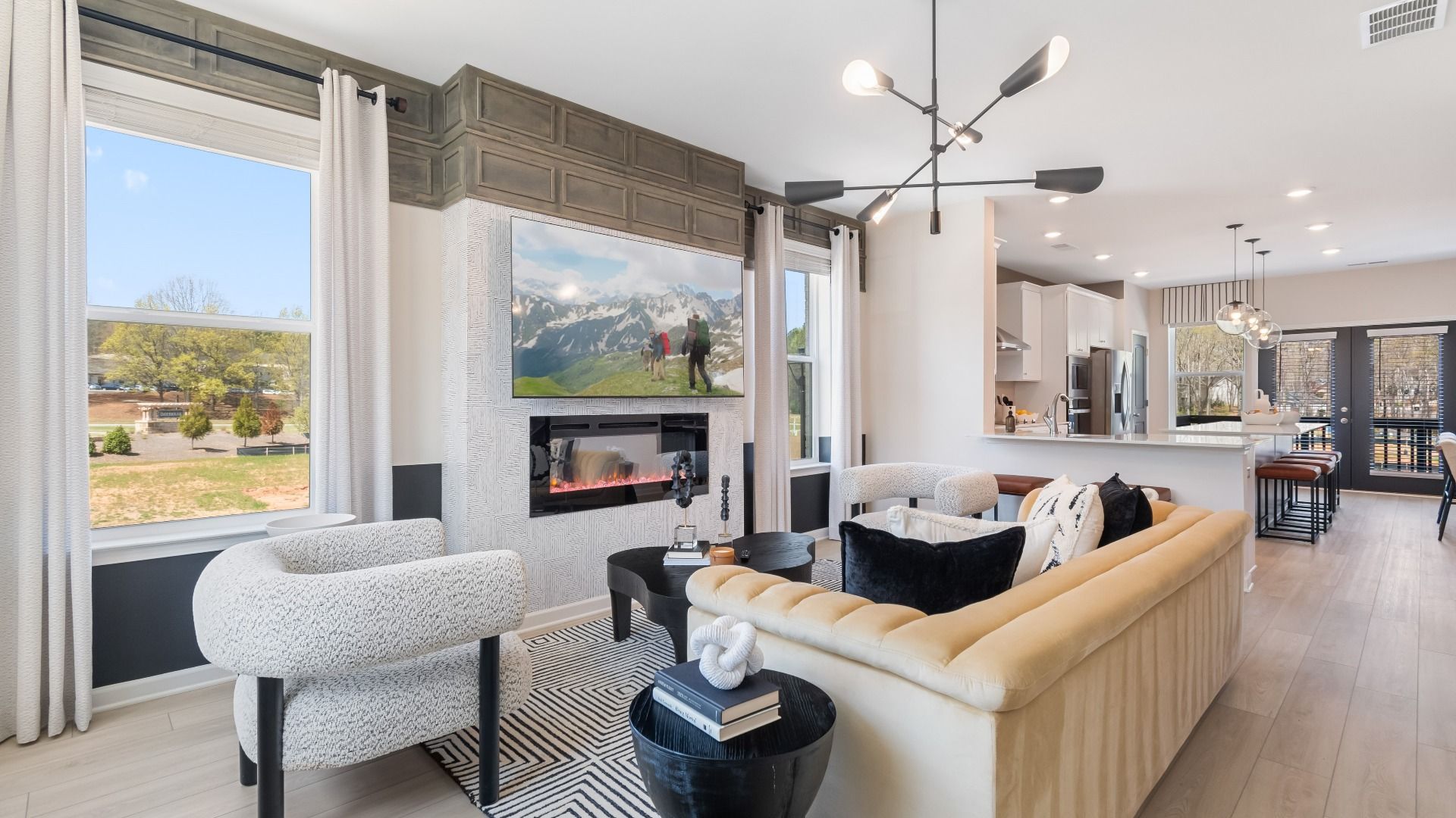 Open family room with seamless kitchen connection and counter seating at new construction townhome at Daybreak.