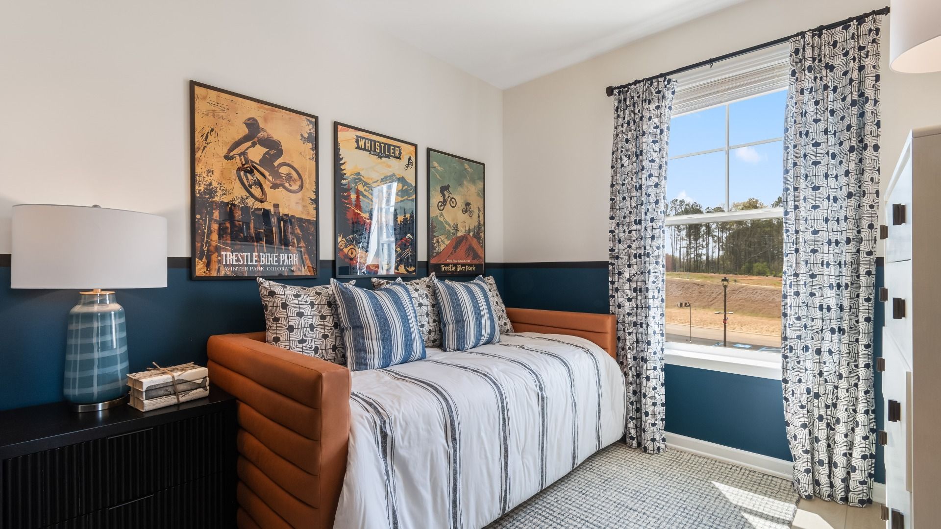 Comfortable secondary bedroom with clean neutral design and natural light at Daybreak in Newnan, GA.