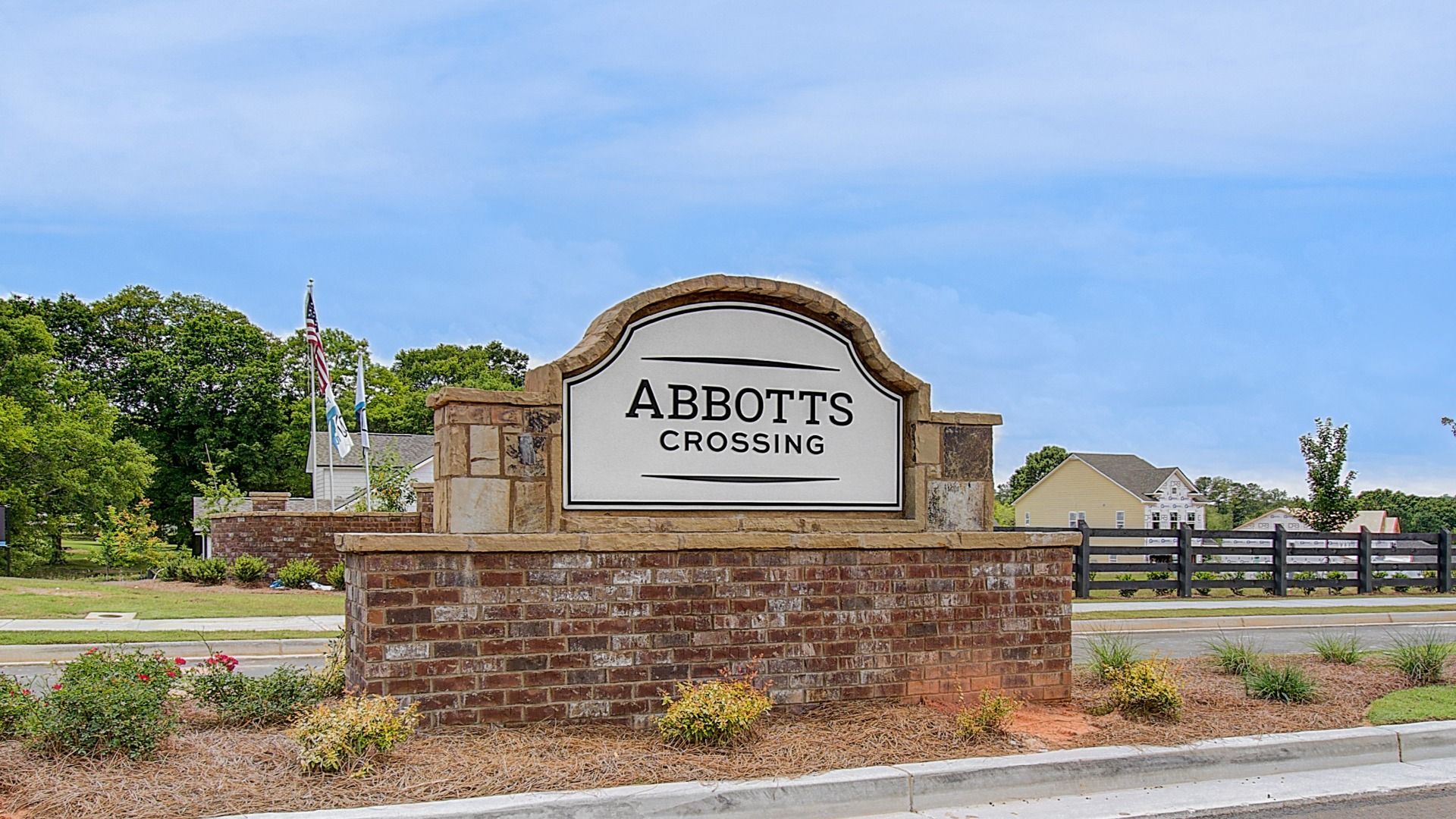 Brick entrance monument welcoming residents and visitors to the Abbotts Crossing community in Conyers, Georgia.