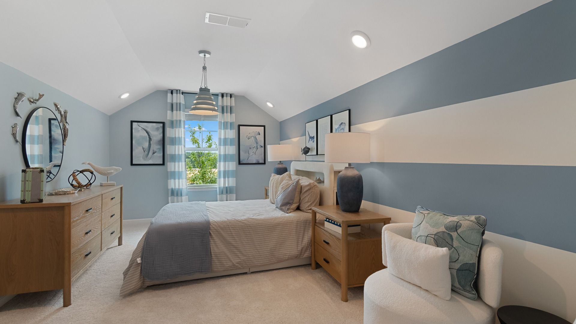 Coastal-themed secondary bedroom with sloped ceiling, blue walls, nautical decor at Abbotts Crossing single family home.