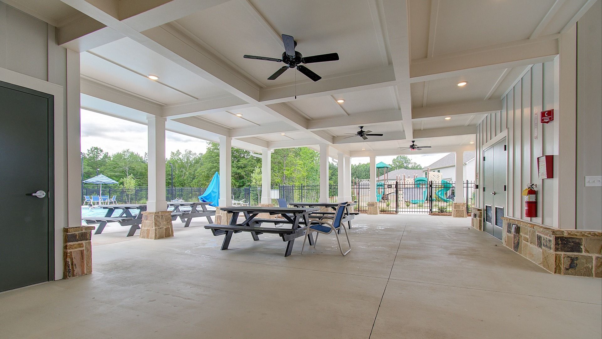 Covered pavilion with open seating overlooking pool and playground at Kingston in Locust Grove, GA.