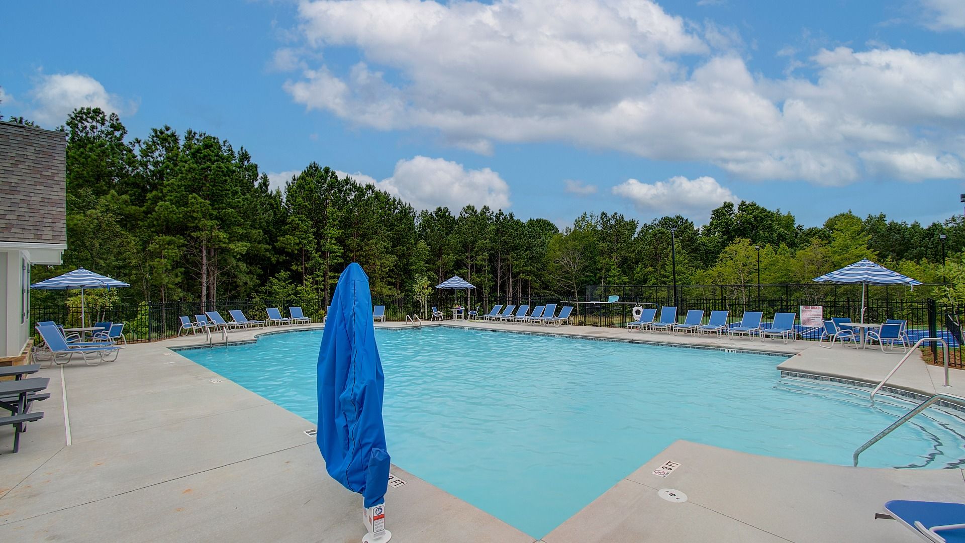 Resort-style community pool with lounge seating at Kingston in Locust Grove, GA.